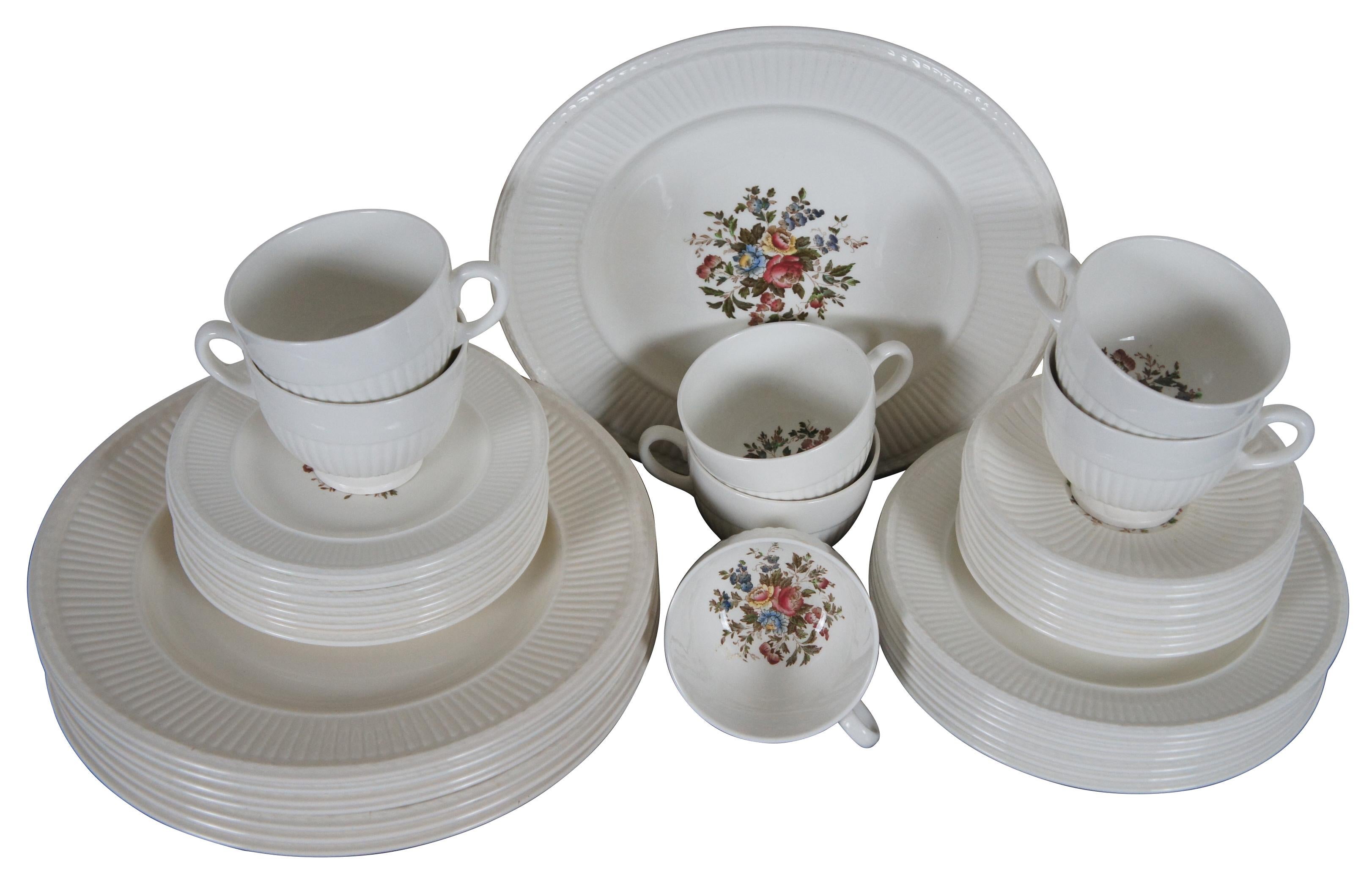 Antique and vintage 38 piece dinnerware set by Wedgwood Edme & Barlston in the Conway pattern featuring a ribbed and laurel leaf border and floral center; a few of the dinner plates are of more current make of the pattern and have slightly different