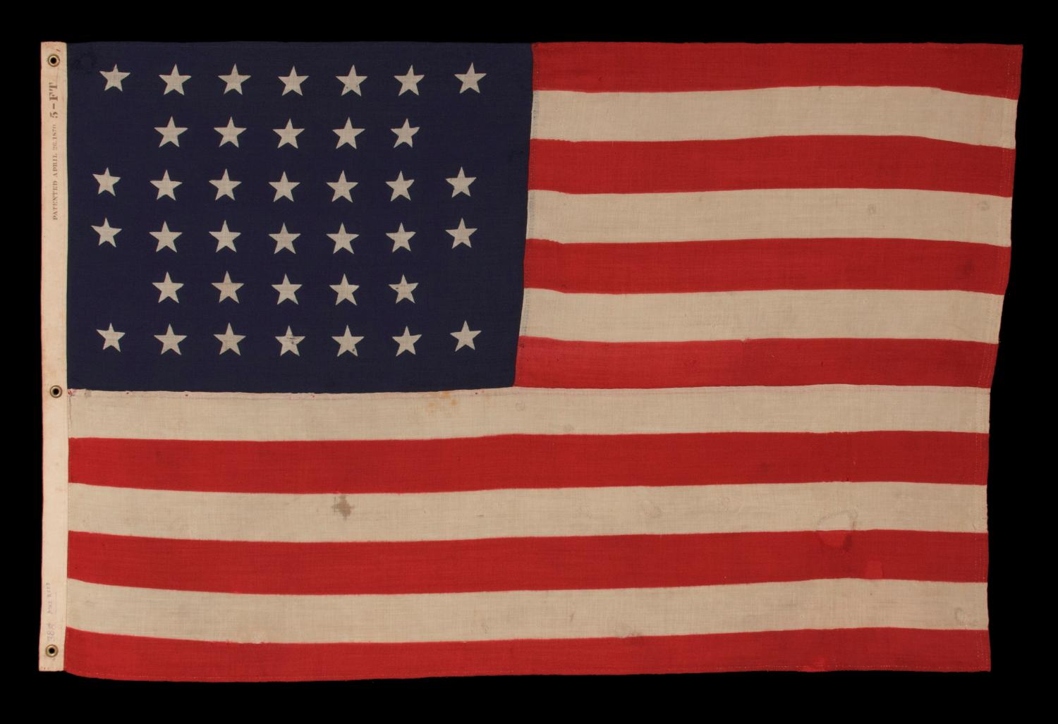 38 STARS IN A NOTCHED, CROSSHATCH PATTERN ON AN ANTIQUE AMERICAN FLAG MADE BY THE U.S. BUNTING COMPANY IN LOWELL, MASSACHUSETTS, 1876-1889, COLORADO STATEHOOD; EX-WHITNEY SMITH COLLECTION (THE MAN WHO COINED THE TERM VEXILLOLOGY) 

38 star American