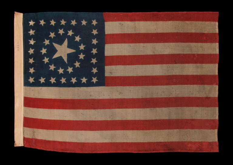 38 STARS IN A RARE CIRCLE-IN-A-SQUARE MEDALLION WITH A HUGE CENTER STAR, ON AN ANTIQUE AMERICAN FLAG MADE BY HORSTMANN BROS. IN PHILADELPHIA FOR THE 1876 CENTENNIAL INTERNATIONAL EXPOSITION 

38 star American national parade flag, press-dyed on wool
