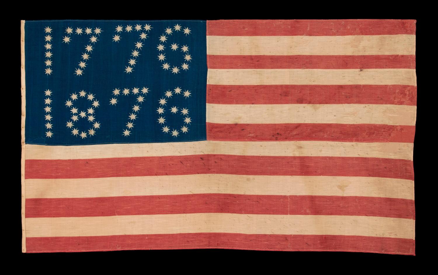Antique American flag with 10-pointed stars that spell “1776 – 1876”, made for the 100-year anniversary of American Independence, one of the most graphic of all early examples:

Many fantastic star patterns were made in the patriotism that