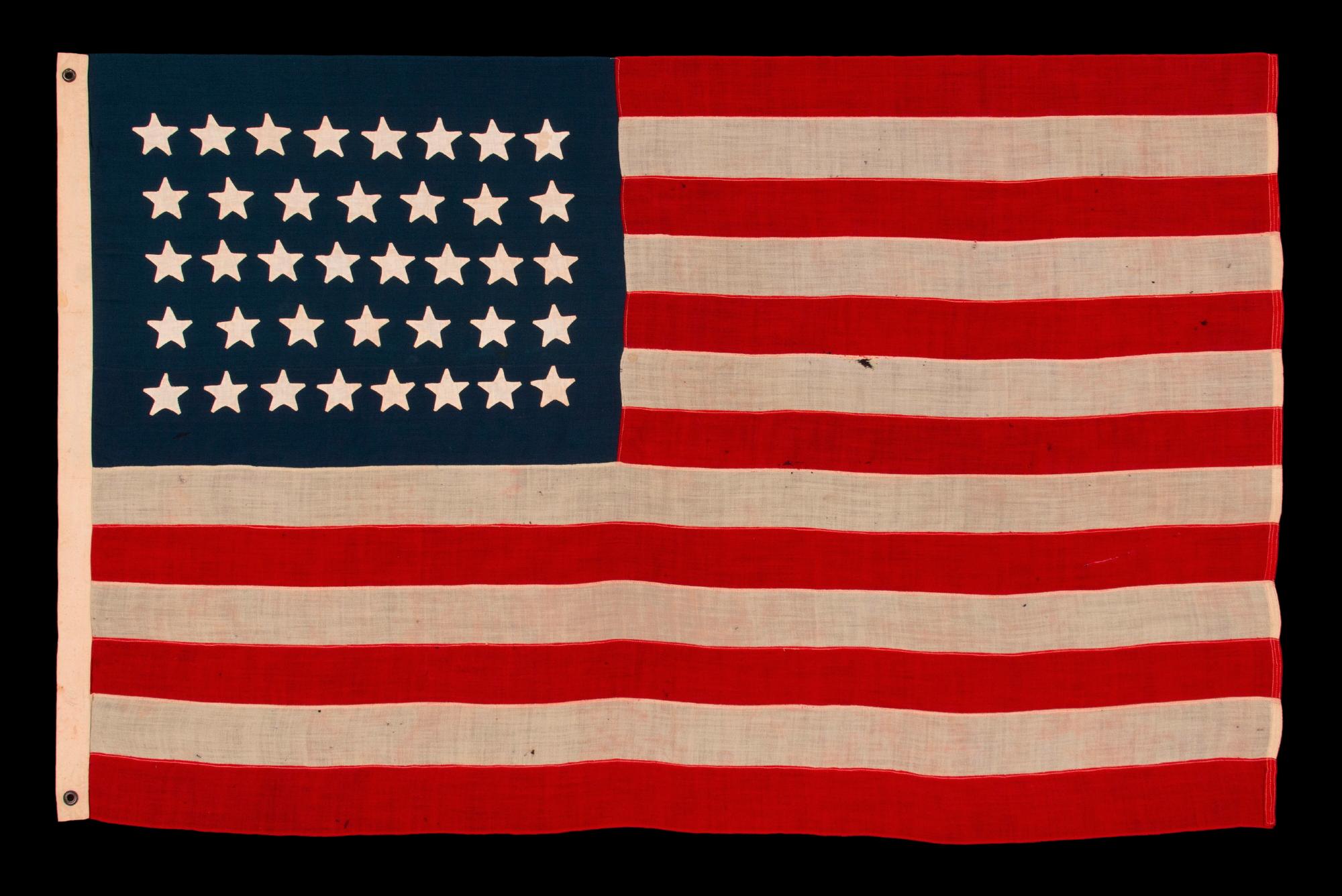 38 STAR ANTIQUE AMERICAN FLAG WITH HAND-SEWN STARS IN AN 8-7-8-7-8 PATTERN OF JUSTIFIED ROWS, MADE IN THE PERIOD WHEN COLORADO WAS THE MOST RECENT STATE TO JOIN THE UNION, 1876-1889

38 star American national flag, made in the period when Colorado
