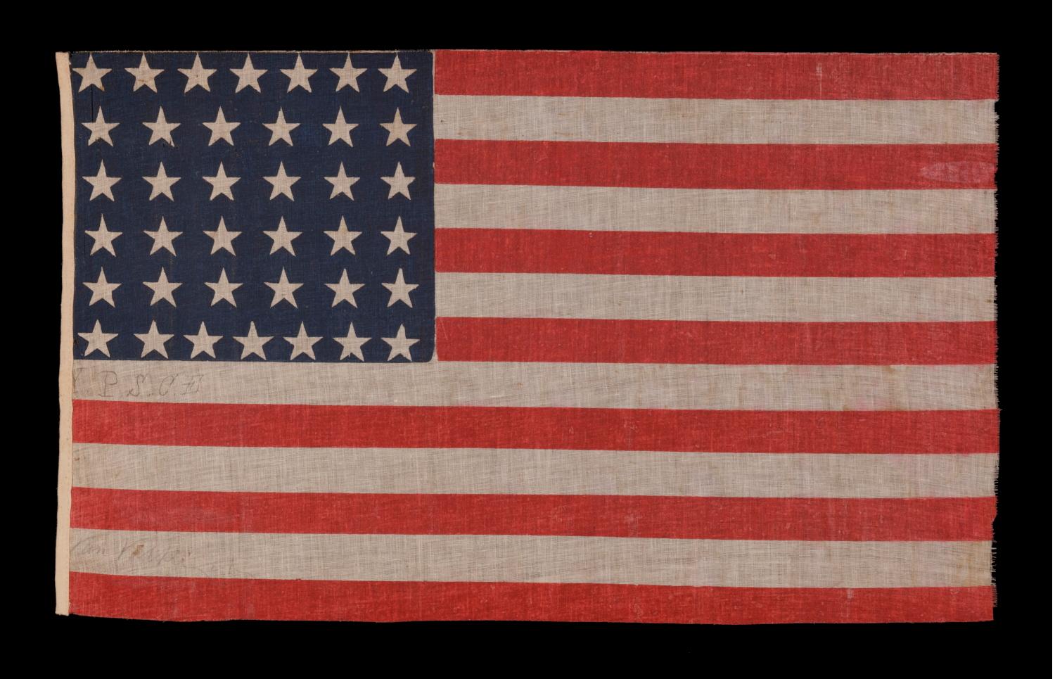38 STAR ANTIQUE AMERICAN FLAG, MADE DURING THE PERIOD WHEN COLORADO WAS THE MOST RECENT STATE TO JOIN THE UNION, 1876-1889, WITH PENCILED INSCRIPTION FROM THE YOUNG PEOPLE'S SOCIETY OF CHRISTIAN ENDEAVOR (YPSCE), EX-RICHARD PIERCE COLLECTION OF