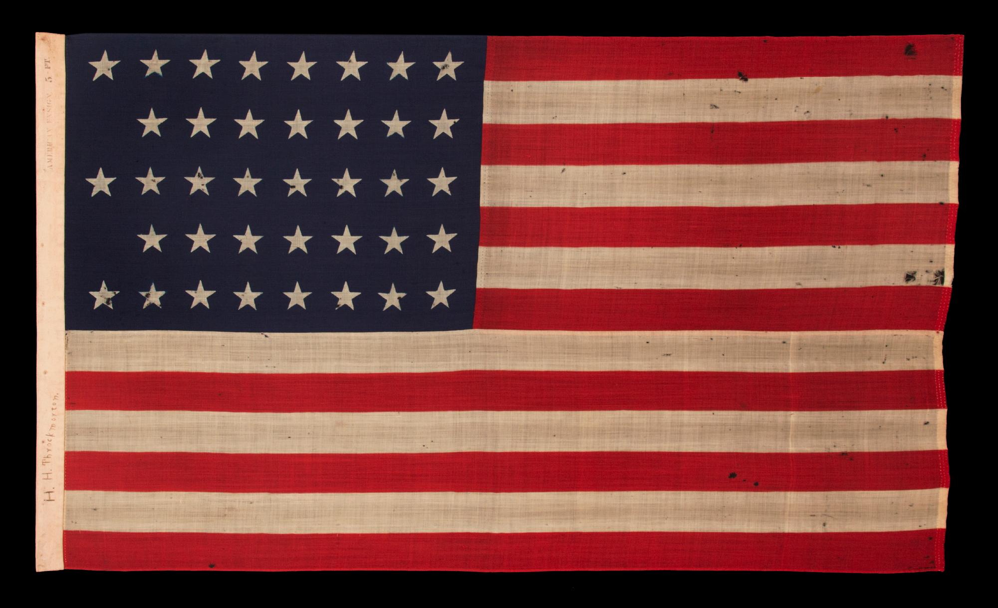 38 Star antique American flag with a notched configuration, made by the U.S. bunting company in Lowell, Massachusetts, signed 