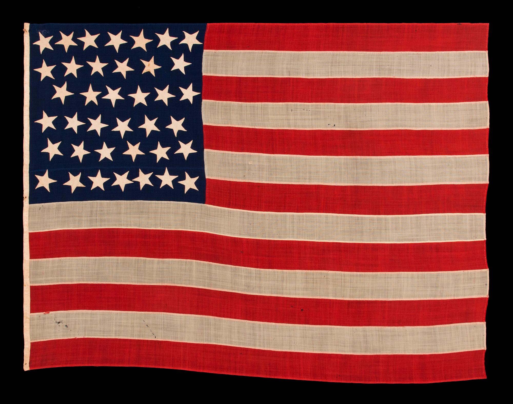 Entirely hand sewn, 38 Star, antique American flag of the Indian wars period, with a Squarish profile and a canton that is taller than it is wide, similar to U.S. infantry and artillery battle flags, and with an especially graphic presentationof