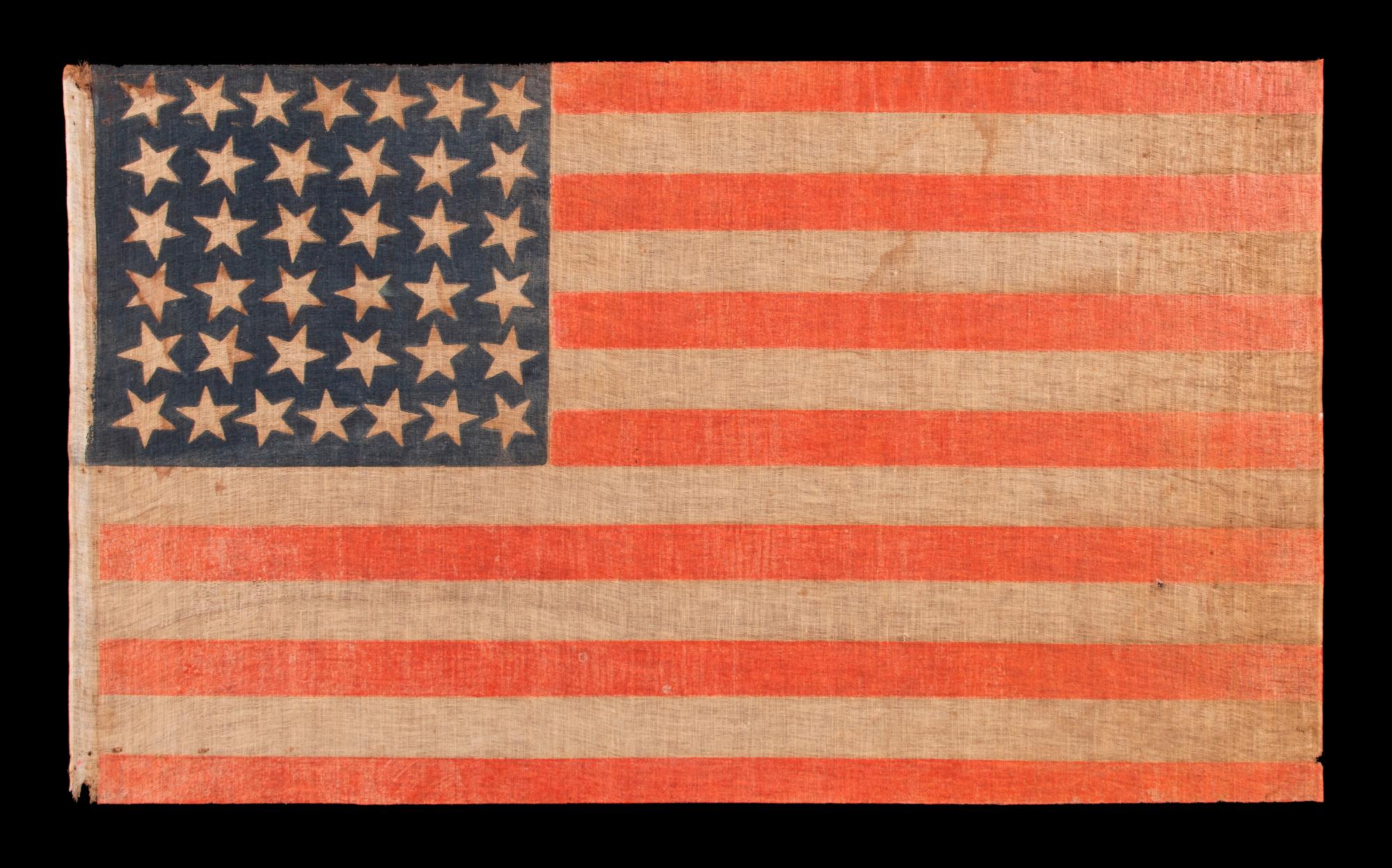 38 STAR ANTIQUE AMERICAN PARADE FLAG WITH JUSTIFIED ROWS OF 7-6-6-6-6-7 AND SCATTERED STAR ORIENTATION, MADE DURING THE PERIOD WHEN COLORADO WAS THE MOST RECENT STATE TO JOIN THE UNION, 1876-1889

38 star American national parade flag, printed on