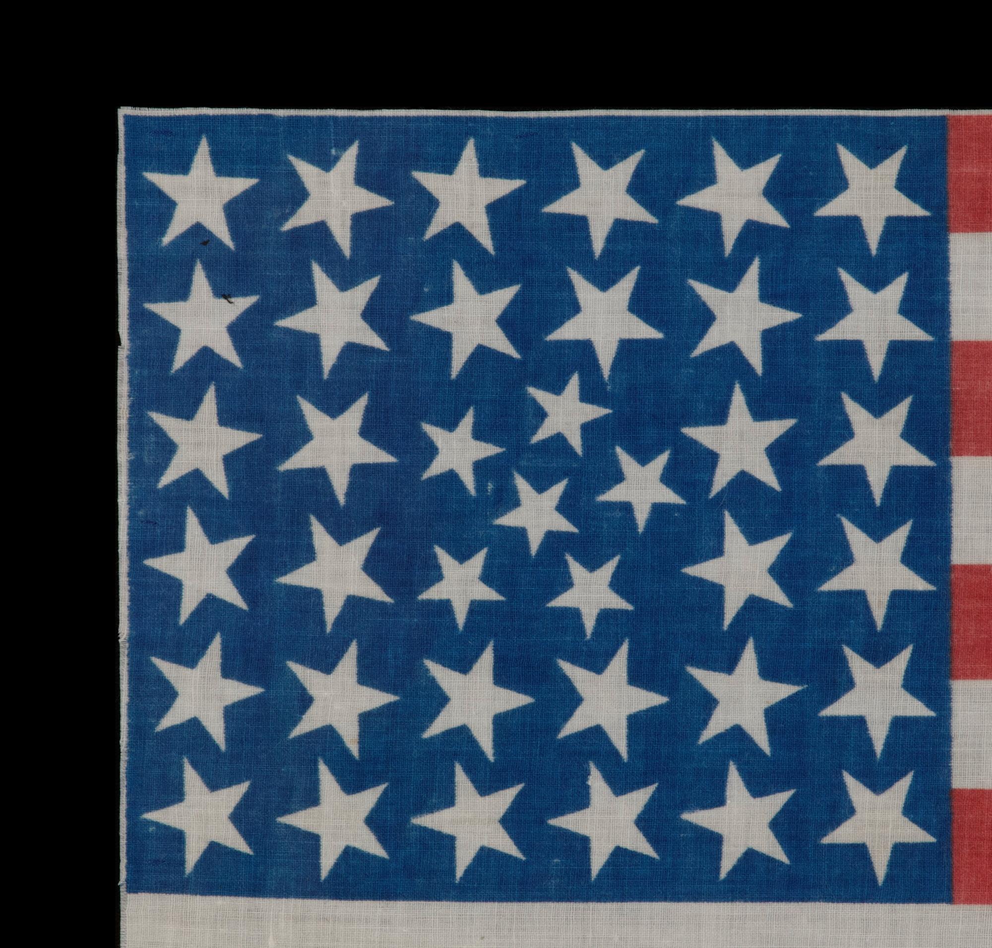 38 STARS IN AN EXTREMELY UNUSUAL CONFIGURATION THAT BEARS A CLUSTER OF 6 SMALL STARS WITHIN A LINEAL PATTERN OF LARGER STARS, 1876-1889, COLORADO STATEHOOD

38 star American national parade flag, printed on cotton. This is an extremely rare example