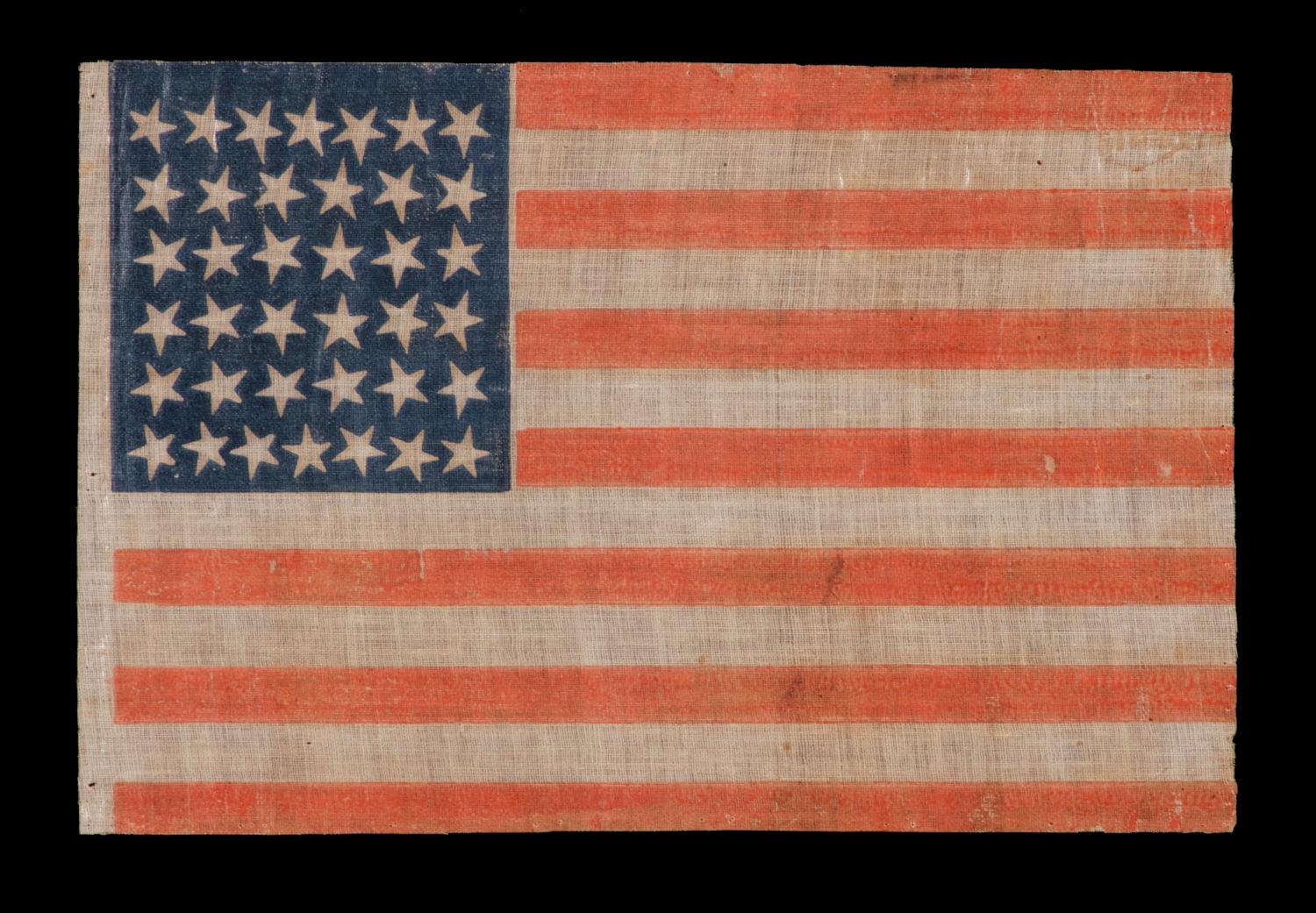 38 star antique American flag with scattered star positioning made during the period when Colorado was the most recent state to join the union, 1876-1889

38 star American national parade flag, printed on coarse cotton. The stars are arranged in