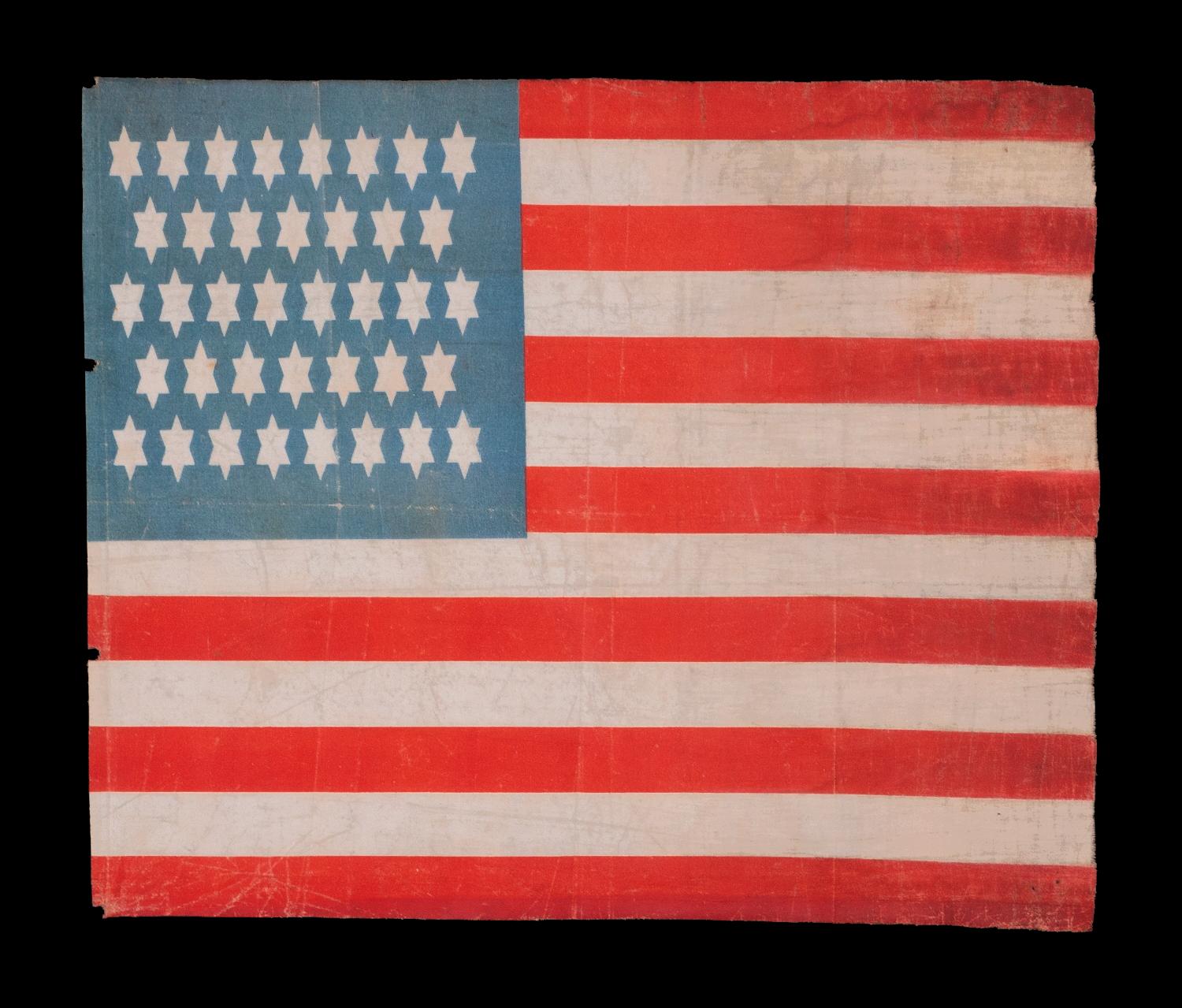 38 WHIMSICAL STARS, WITH 6-POINTED PROFILES, SIMILAR TO THE STAR OF DAVID, ON AN ANTIQUE AMERICAN FLAG OF THE CENTENNIAL ERA; A REMARKABLE SPECIMEN, ONE-OF-A-KIND AMONG KNOWN EXAMPLES, REFLECTS COLORADO STATEHOOD, 1876-1889 

This remarkable 38 star