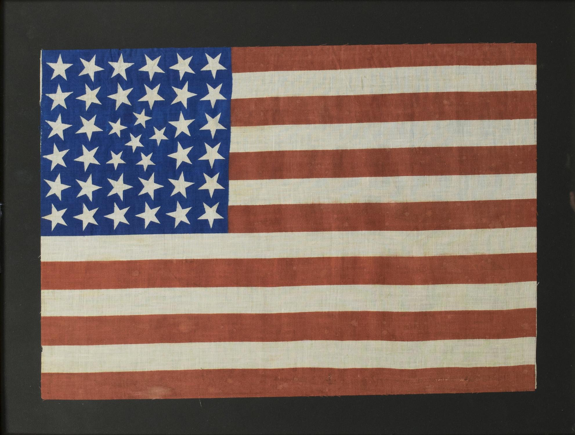 38 star flag with small cluster of stars. Print on linen. Colorado gained statehood in 1877. Unusual star pattern. Flag 12