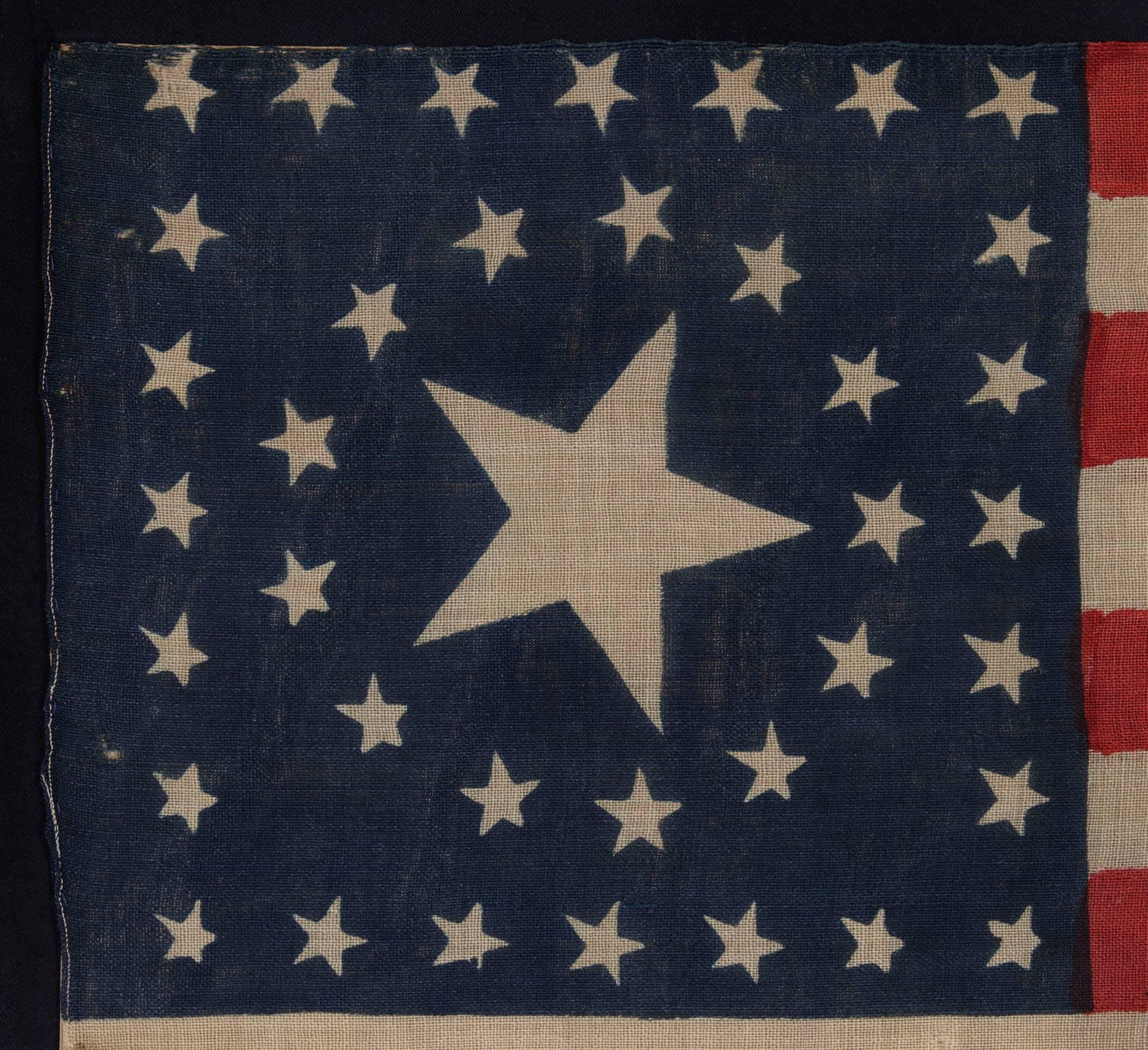 38 STARS IN A RARE CIRCLE-IN-A-SQUARE MEDALLION WITH A HUGE CENTER STAR, ON AN ANTIQUE AMERICAN FLAG MADE FOR THE 1876 CENTENNIAL CELEBRATION BY HORSTMANN BROS. OF PHILADELPHIA:

38 star American national flag, press-dyed on wool bunting. The stars