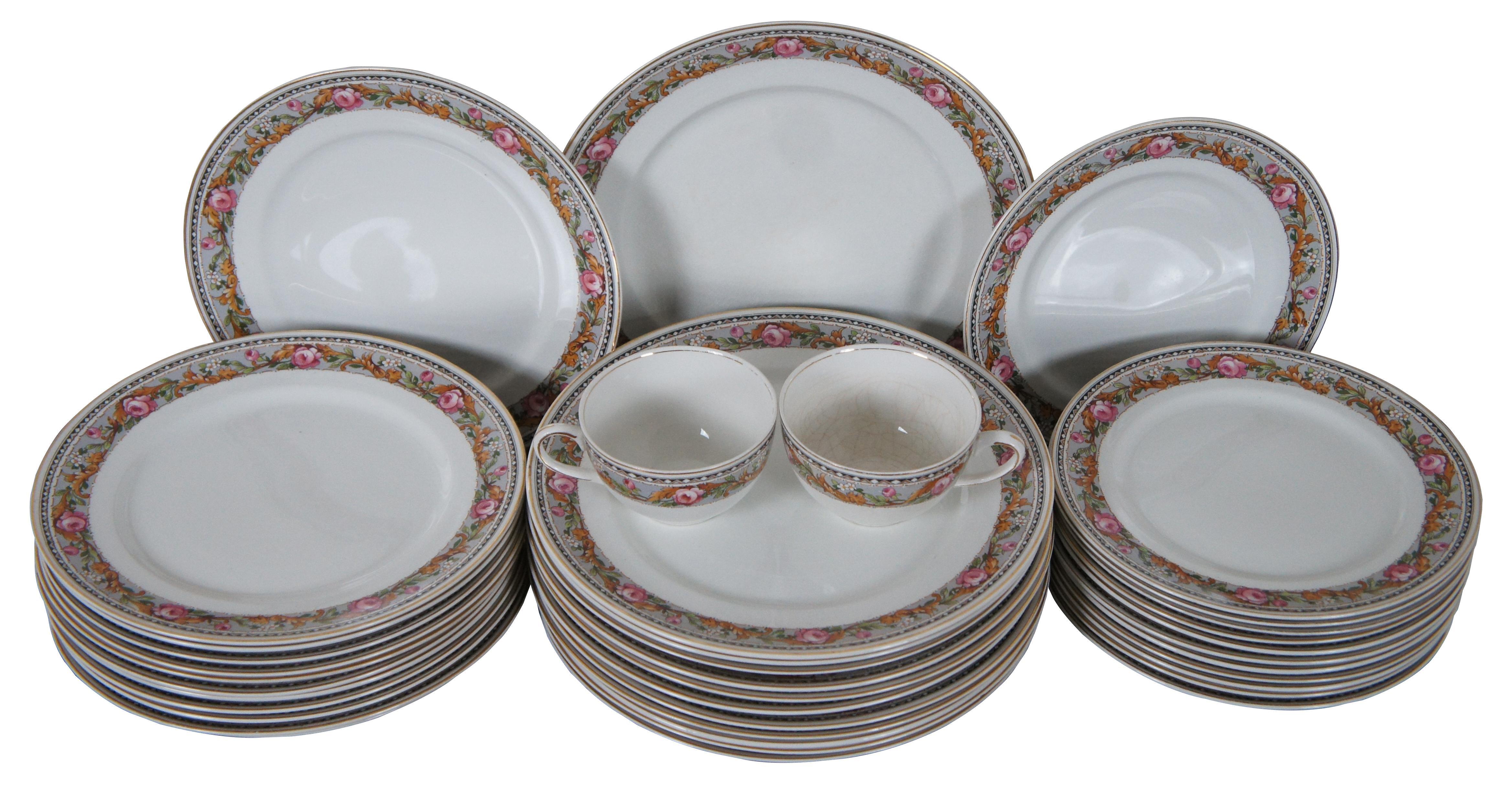 38 Pieces of vintage Alfred Meakin England dinnerware featuring dinner, salad, bread plates and two teacups. Design features gray borders with green and orange floral foliate design accented by pink roses. Marked on back The Tunis.

12 Dinner