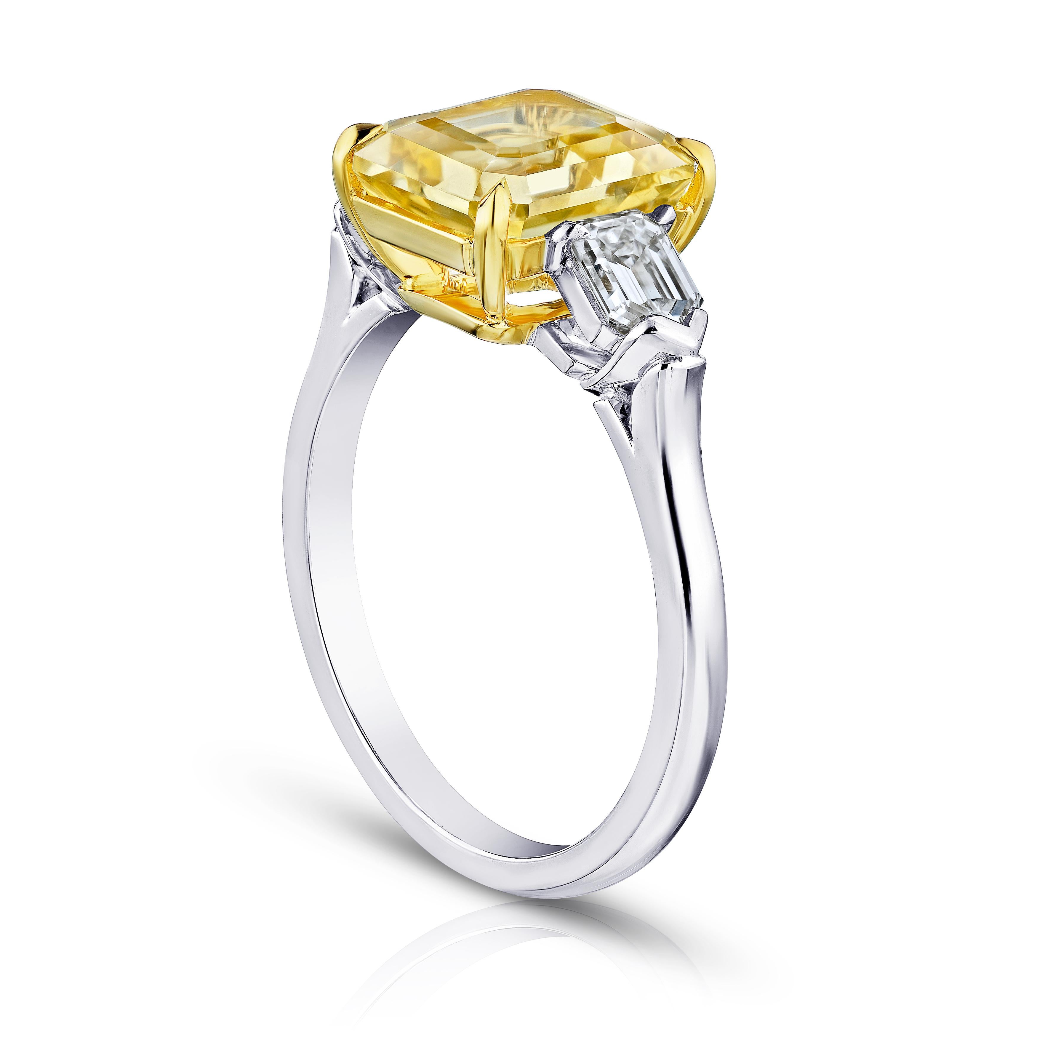 3.80 carat emerald cut yellow sapphire (no heat) with bullet shape diamonds .74 carats set in a platinum and 18k yellow gold ring.