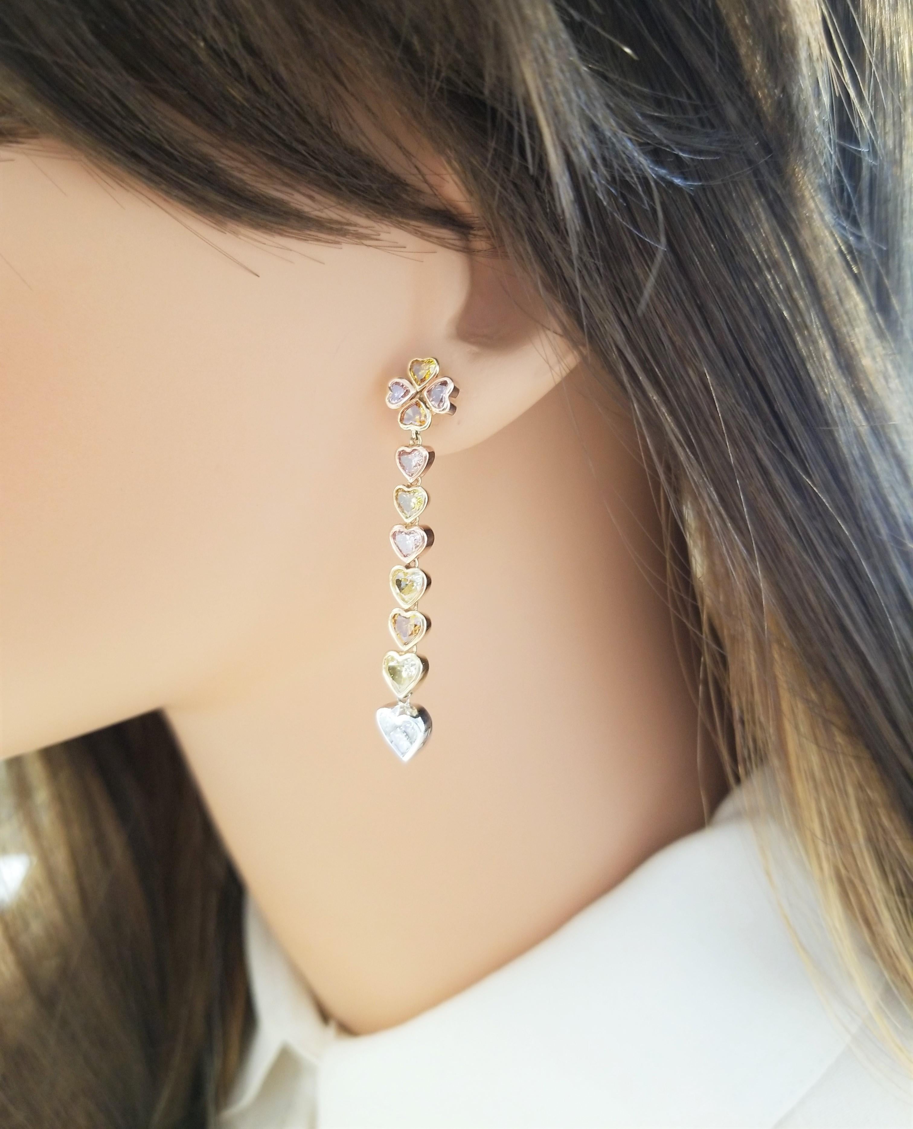 Hearts, hearts, and more hearts! These lavish diamond dangle earrings feature diamond hearts for days!  The earrings include 3.80 carat total of natural fancy colored heart shaped diamonds in an array of colors: yellow, orange, pink, and