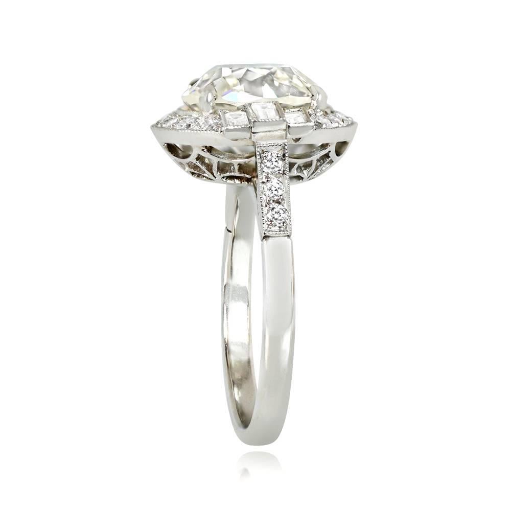This elegant engagement ring has a 3.80 carat old European cut diamond with approximately K color and VS2 clarity. It has a diamond halo and three baguette-cut diamonds on each side. Handcrafted with a low profile and platinum mounting, it showcases