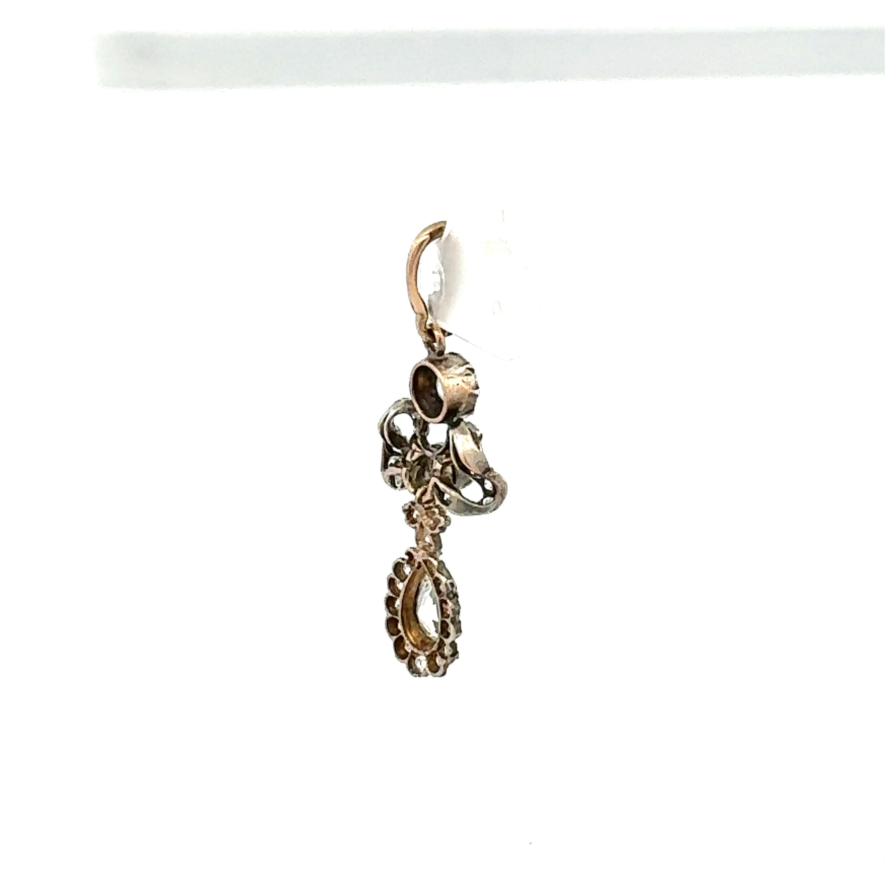 Titel:
Dieser außergewöhnliche antike Anhänger präsentiert eine atemberaubende Mischung aus Diamanten im alteuropäischen Schliff und birnenförmigen Diamanten, gefasst in Platin und 18 Karat Gold. In der Mitte hängt ein birnenförmiger Diamant der