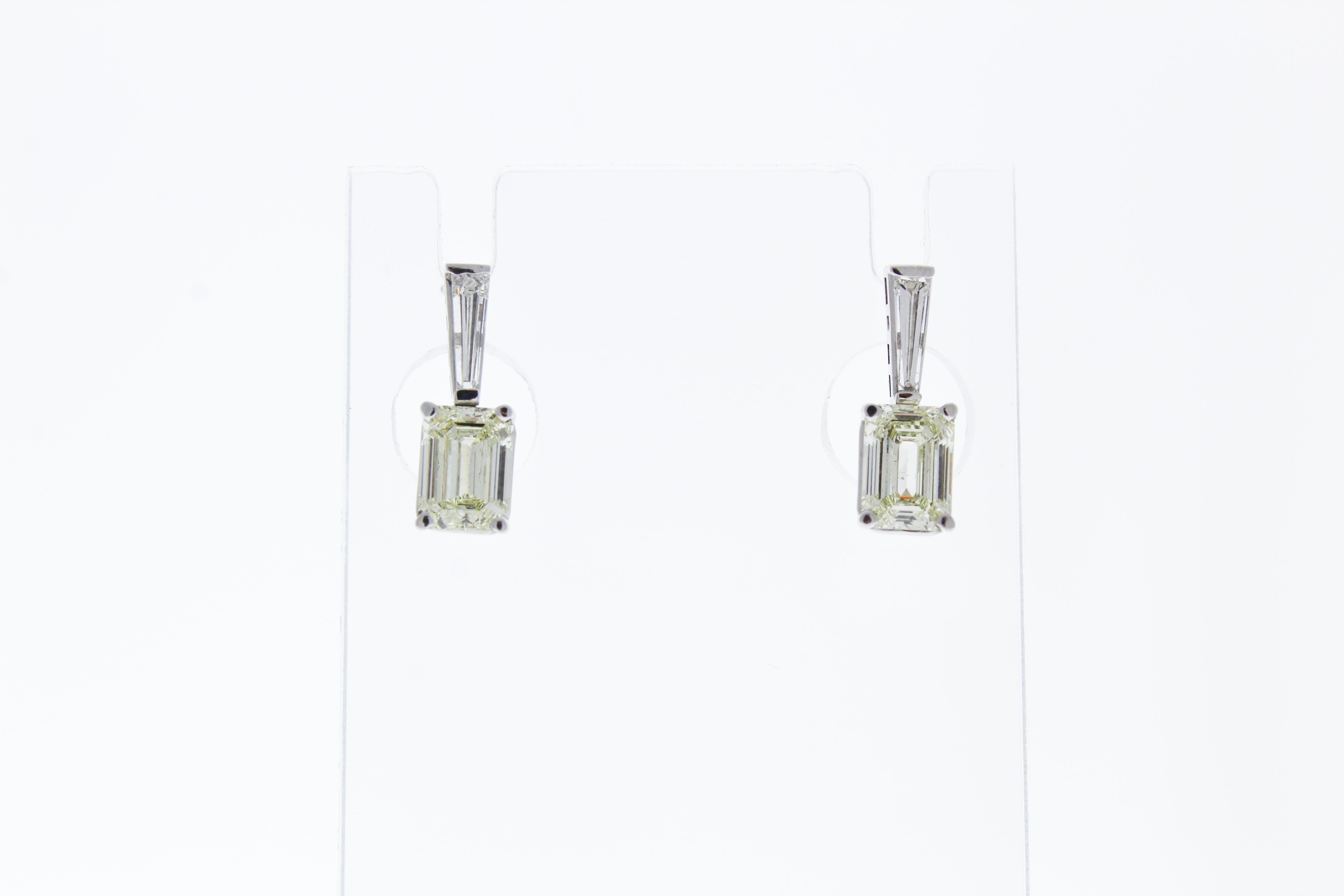 These luxurious 14k White Gold earrings feature multiple mixed cut diamonds that total up to 3.80CTW. The mixed cut diamonds give the illusion that it is a whole diamond.