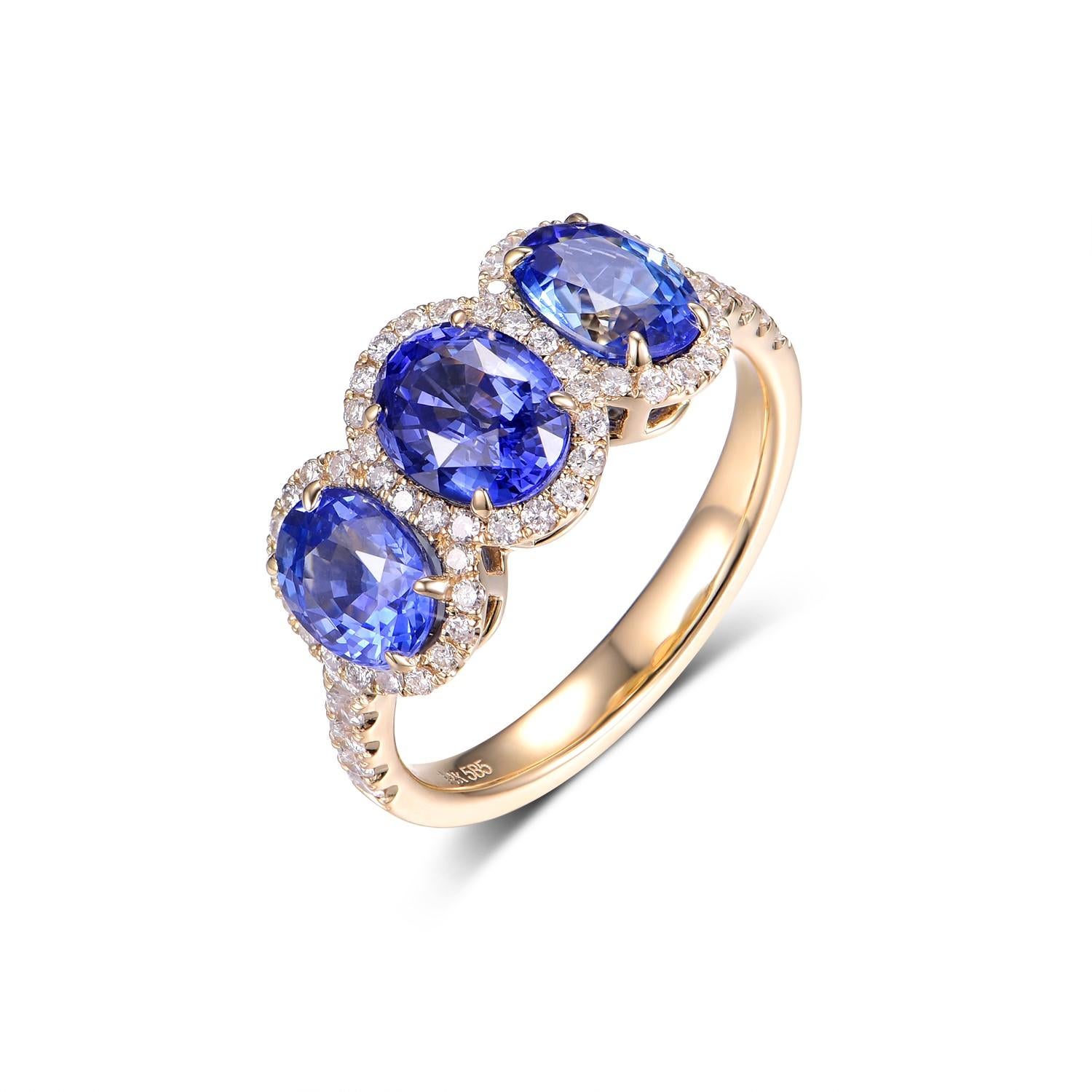 Unveiling a timeless elegance perfect for daily wear, this ring effortlessly marries simplicity with luxury. Nestled within a setting of luminous 14 karat yellow gold are three resplendent blue sapphires, with a combined weight of 3.31 carats. These