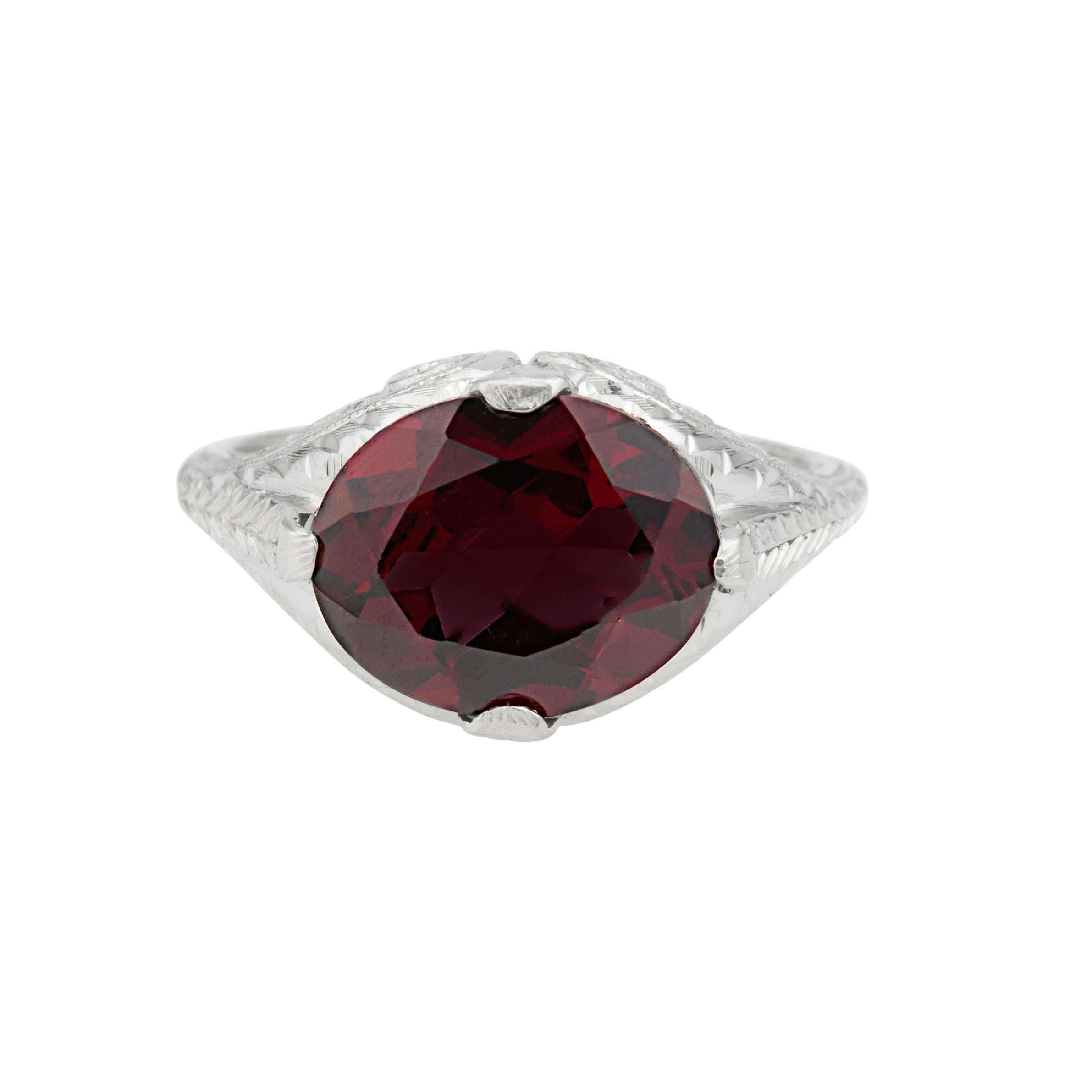 Art Deco 1930’s garnet ring. Oval center garnet set in a 14k white gold hand engraved setting. 

1 oval reddish brown Garnet, approx. total weight 3.81cts, VS, 11 x 9mm
Size: 5.25 and sizable
14k white gold
Tested and stamped: 14k
3.8 grams
Width at