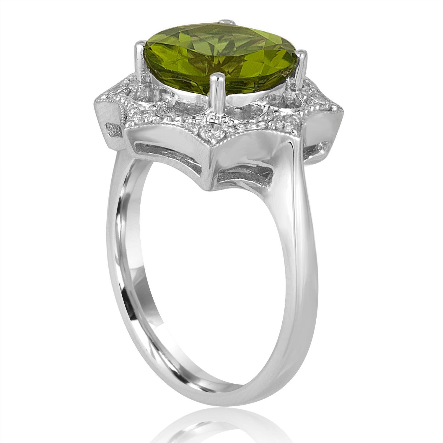 Beautiful Peridot & Diamond Ring.
The ring is 18K White Gold
The center stone is a Round Peridot 3.81 Carats
There is 0.17 Carats in Diamonds H SI
The top of the ring is 16.20mm in diameter.
The ring is a size 6.5, sizable
The ring weighs 6.2 grams