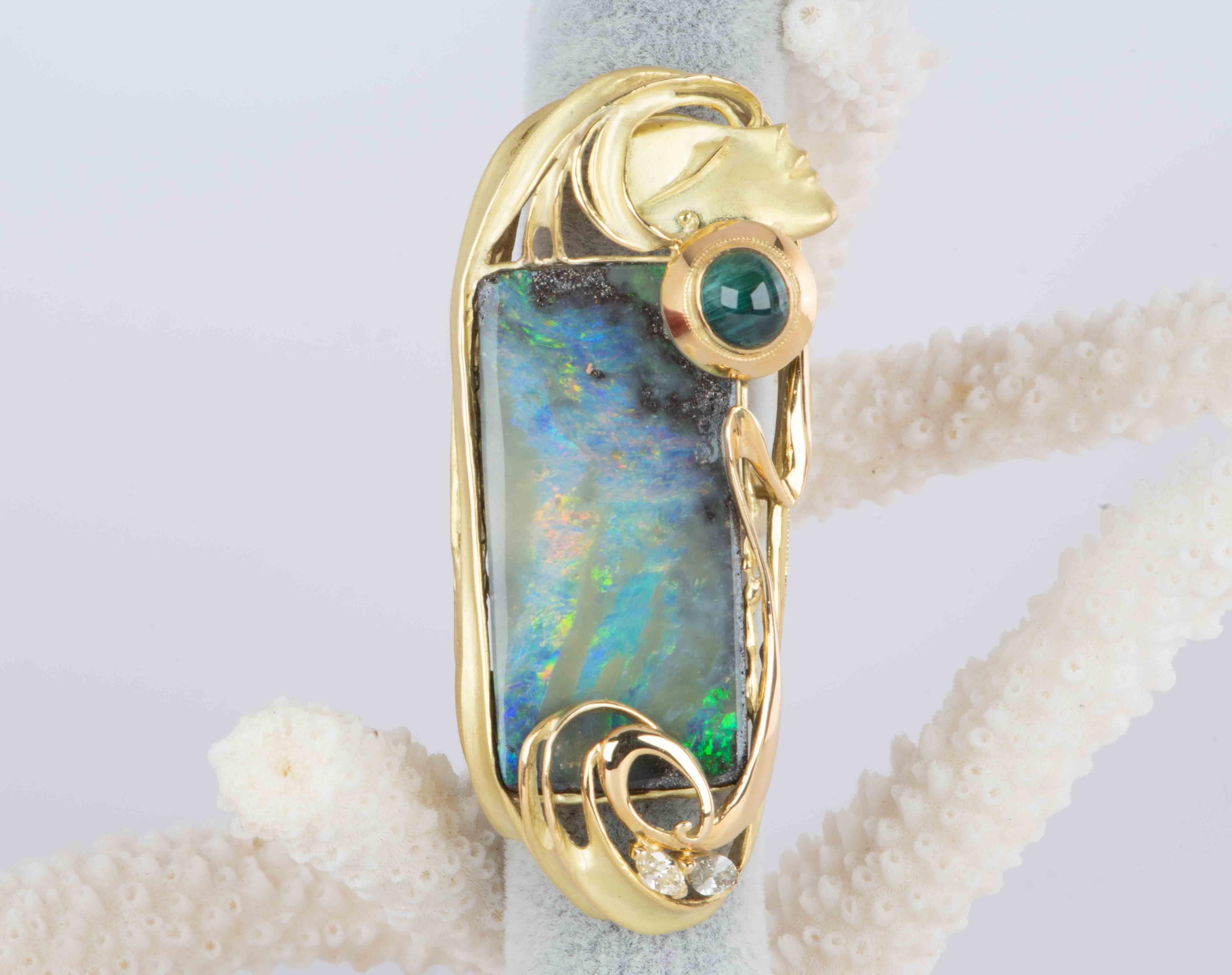 This striking statement piece is crafted from 18K gold and features a stunning Australian boulder opal boasting a weight of 38.17ct! The unique design is structured like an Italian Renaissance painting, casting a soft lady face at the top right