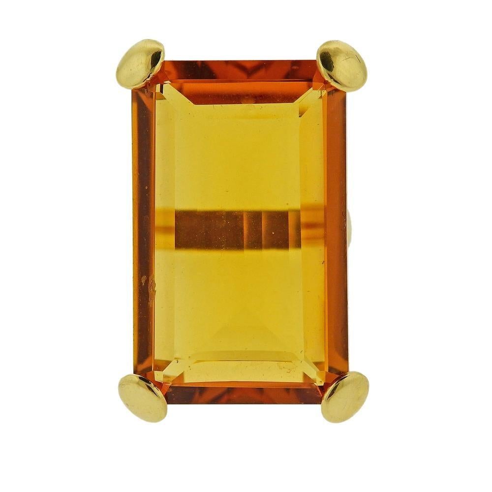18k yellow gold ring with an approx. 38.25 carat emerald cut citrine. Ring size 7.75, ring top - 36mm x 24mm. Marked 750 and with Italian mark. Weighs 18.2 grams.