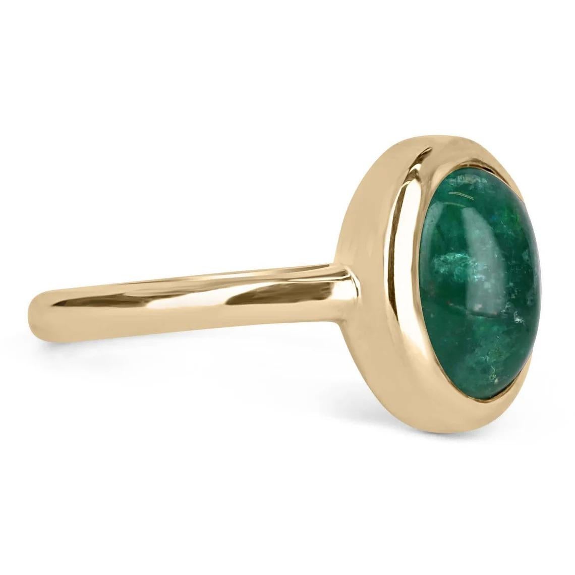 A bezel-set emerald cabochon ring in 14K yellow gold. Featured here is this lovely 3.82-carat natural, earth-mined, emerald cabochon. This stone displays a gorgeous, dark green color, and very good luster. This natural beauty is set in a 14K yellow
