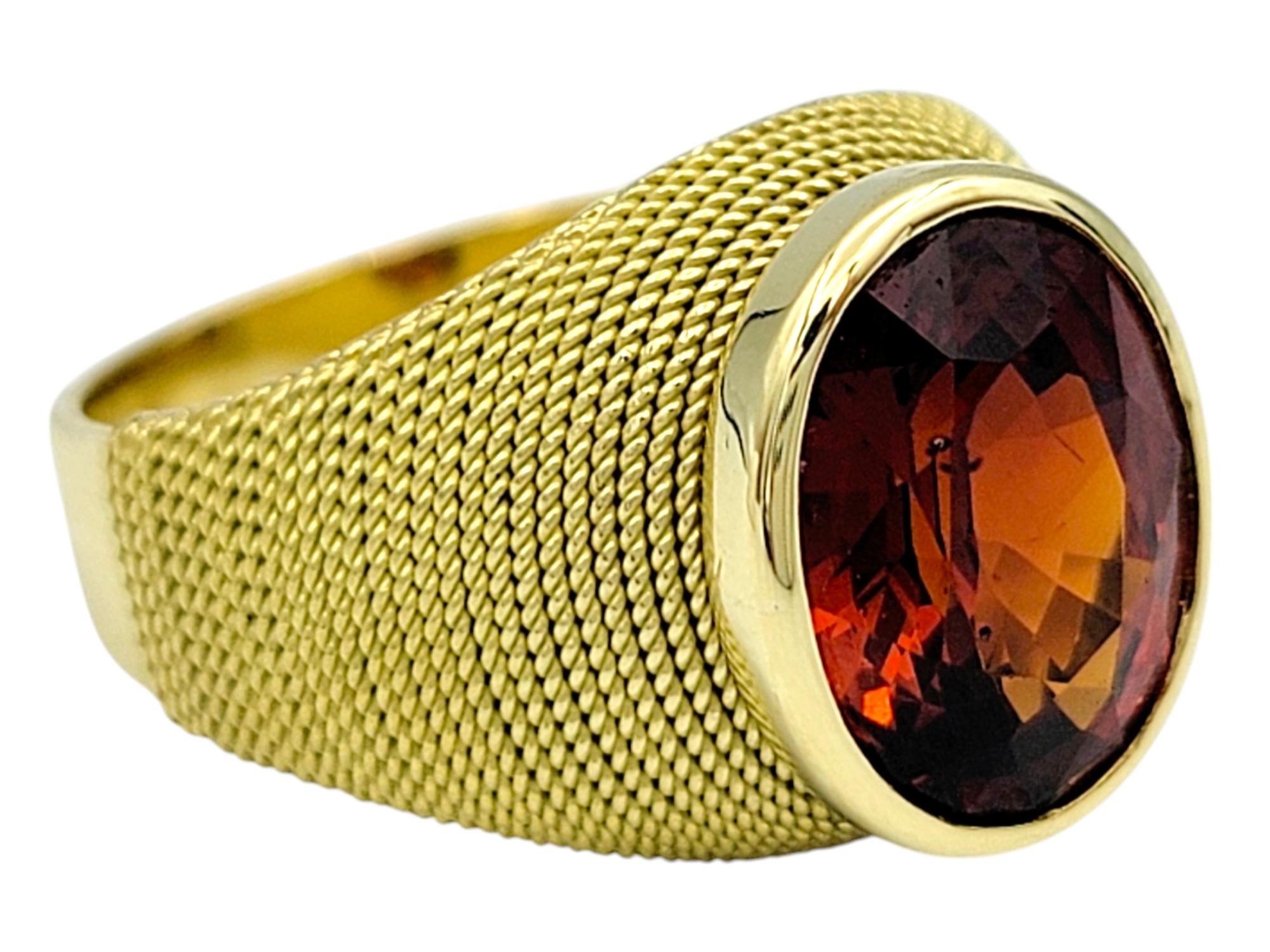 Ring Size: 6.25

This exquisite Spessartite ring is a true statement piece, blending vibrant color with sophisticated design. Set in a luxurious 18 karat yellow gold band, the ring features an eye-catching oval-shaped Spessartite gemstone, which