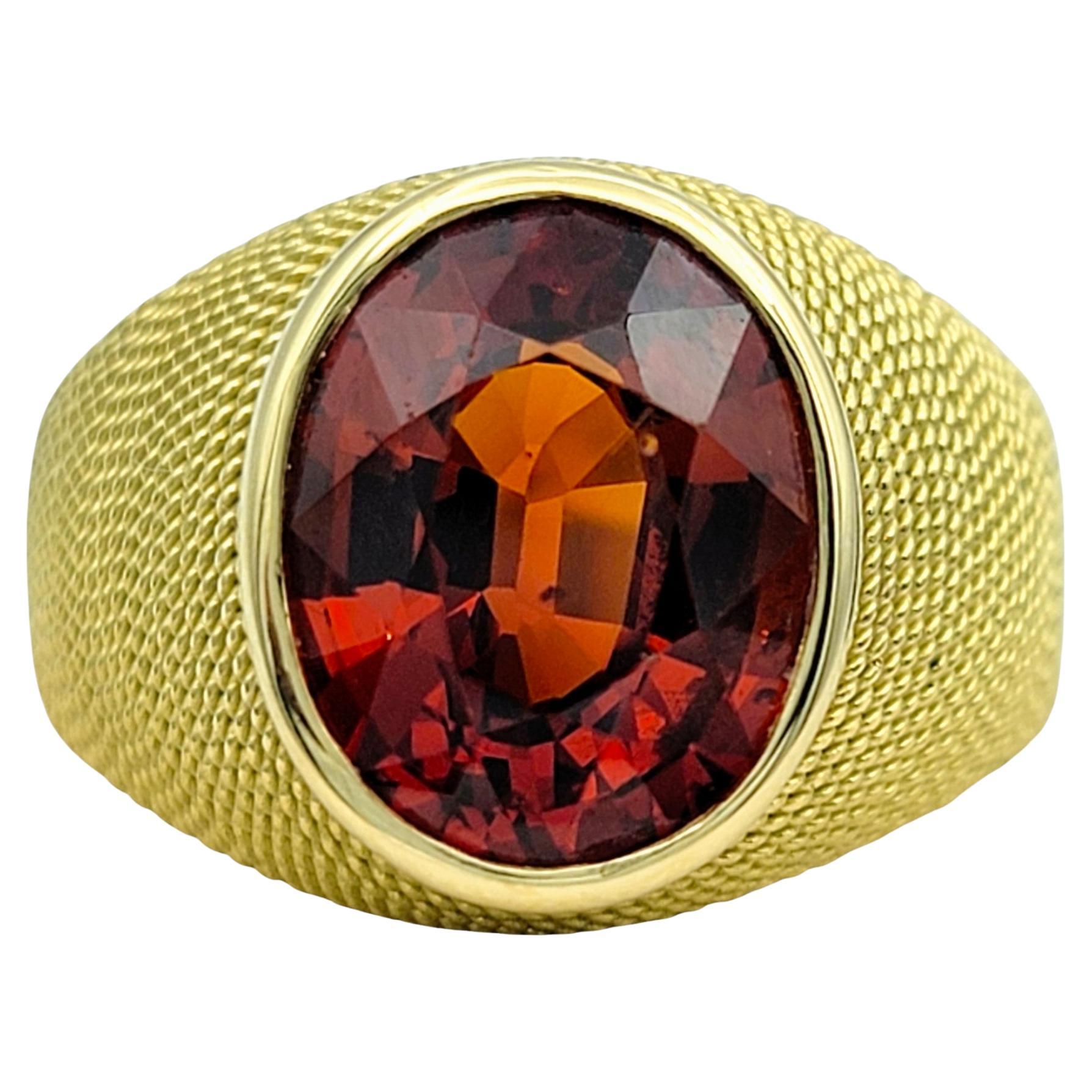 3.83 Carat Oval Cut Spessartite Garnet Ring in Textured 18 Karat Yellow Gold For Sale
