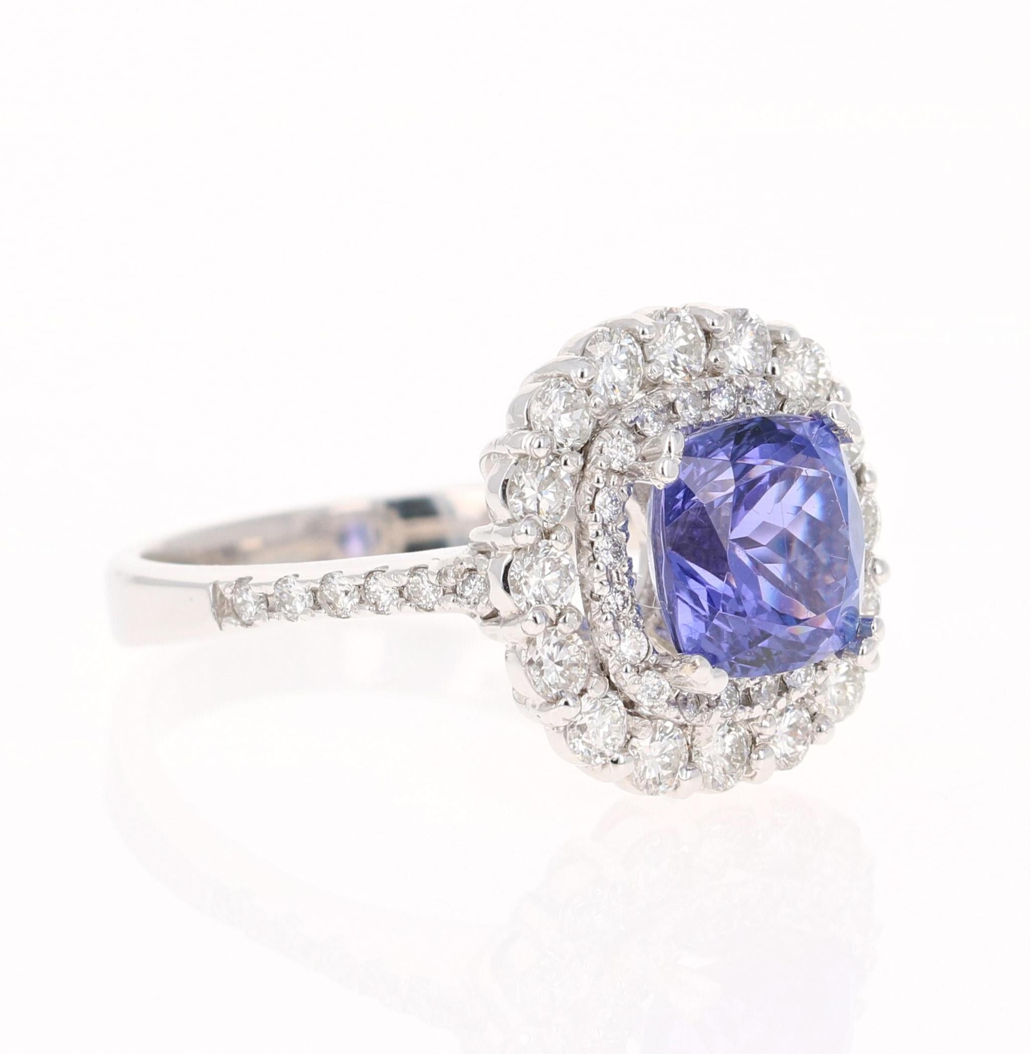 This gorgeous ring has a 2.76 Carat Cushion Cut Tanzanite that is set in the center of the ring. The Tanzanite is surrounded by 2 rows of 47 Round Cut Diamonds that weigh 1.07 carats (Clarity: VS2, Color: F)  The total carat weight of the ring is