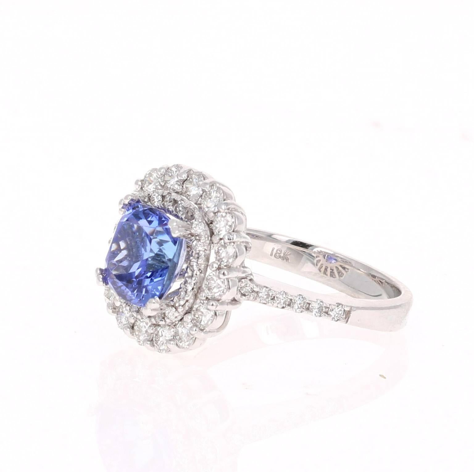 This gorgeous ring has a 2.76 Carat Cushion Cut Tanzanite that is set in the center of the ring.  The Tanzanite is surrounded by 2 rows of 47 Round Cut Diamonds that weigh 1.07 carats (Clarity: VS2, Color: F)  The total carat weight of the ring is