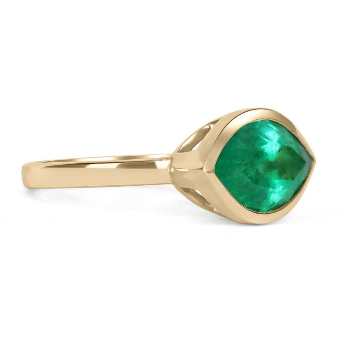 Displayed is a stunning Colombian emerald, marquise cut, solitaire ring. This custom piece is extremely unique, as having emeralds cut in these rare shapes is very uncommon. This natural emerald marquise showcases gorgeous medium green color and