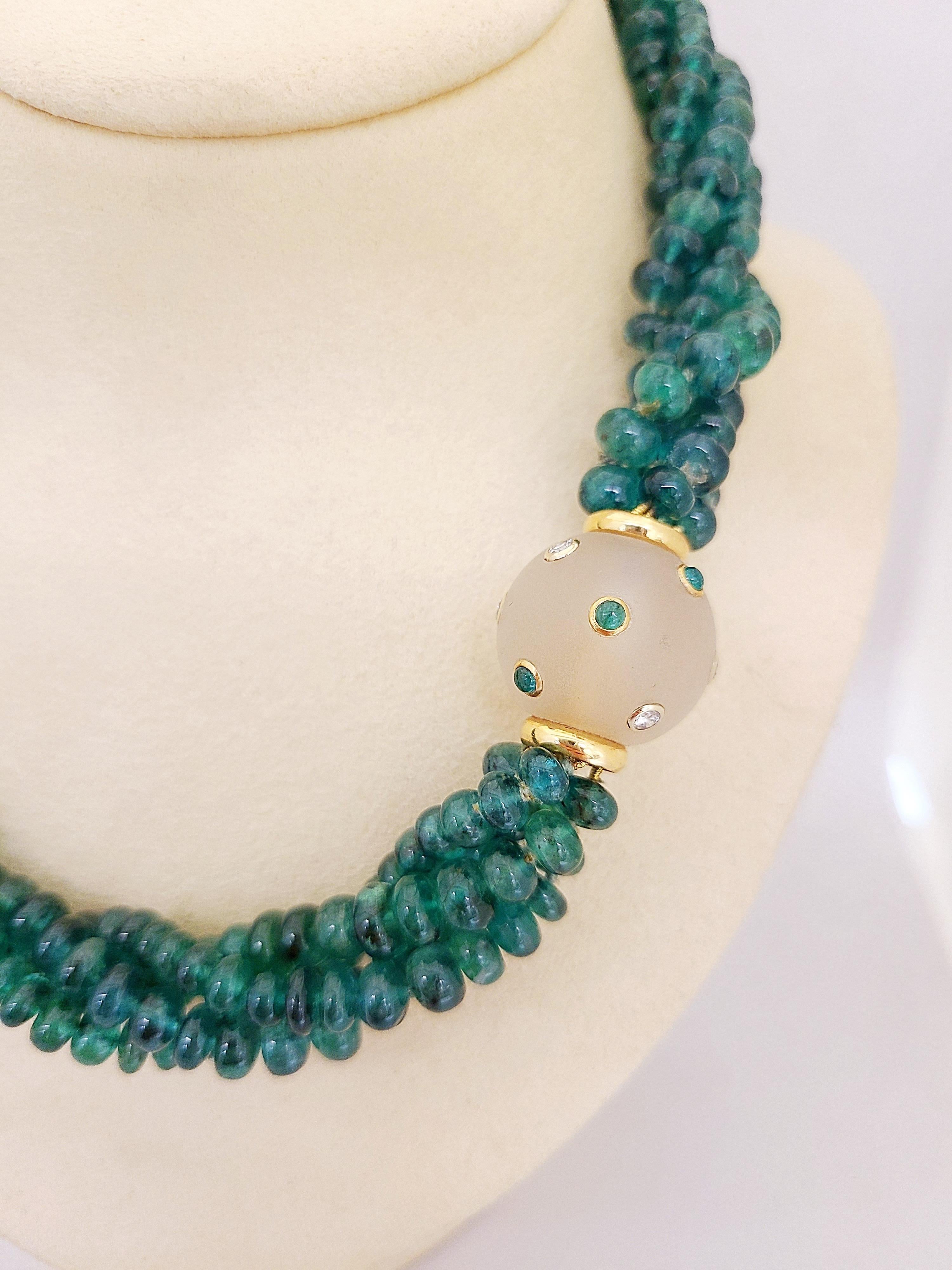 Magnificent classic emerald bead necklace. This necklace has 4 strands of emerald beads measuring approximately 5-6 mm. The strands are held together with a frosted crystal ball screw style clasp. The crystal ball clasp is accented with 18 karat