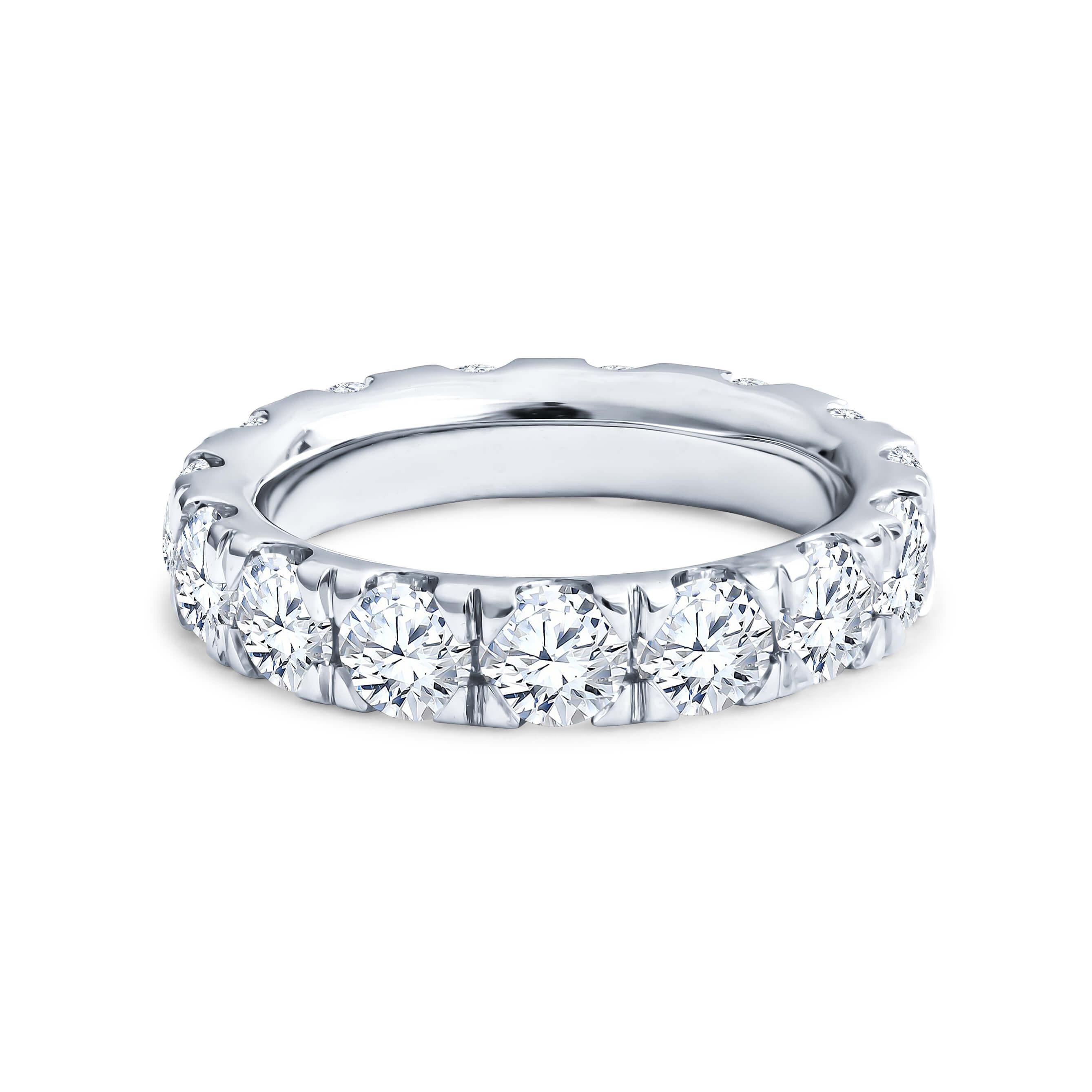This eternity band features 3.83ctw in round brilliant cut diamonds set in 18kt white gold ring with split prongs. The ring is a size 6, 4.25mm wide