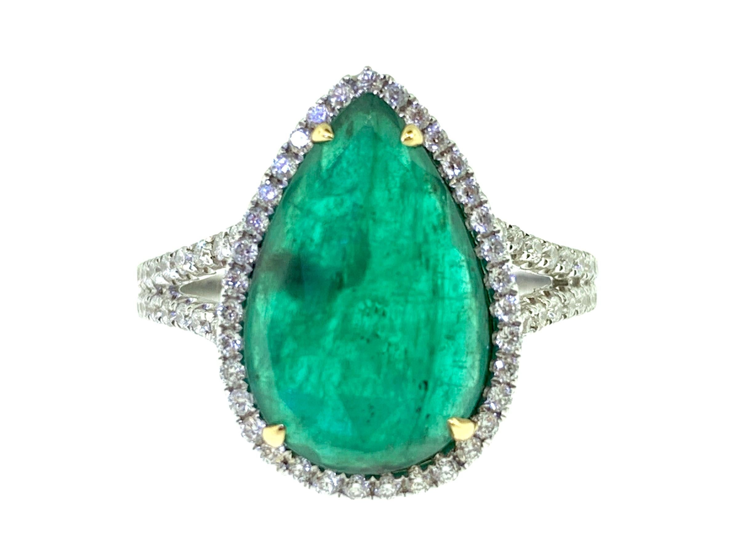 This stunning cocktail ring features a beautiful 3.84 Carat Pear Shape Emerald with a Diamond Halo on a Double Diamond Shank. This ring is set in 18k White Gold with 18k Yellow Gold Prongs on the center stone. 
Total Diamond Weight = 0.44 Carats.