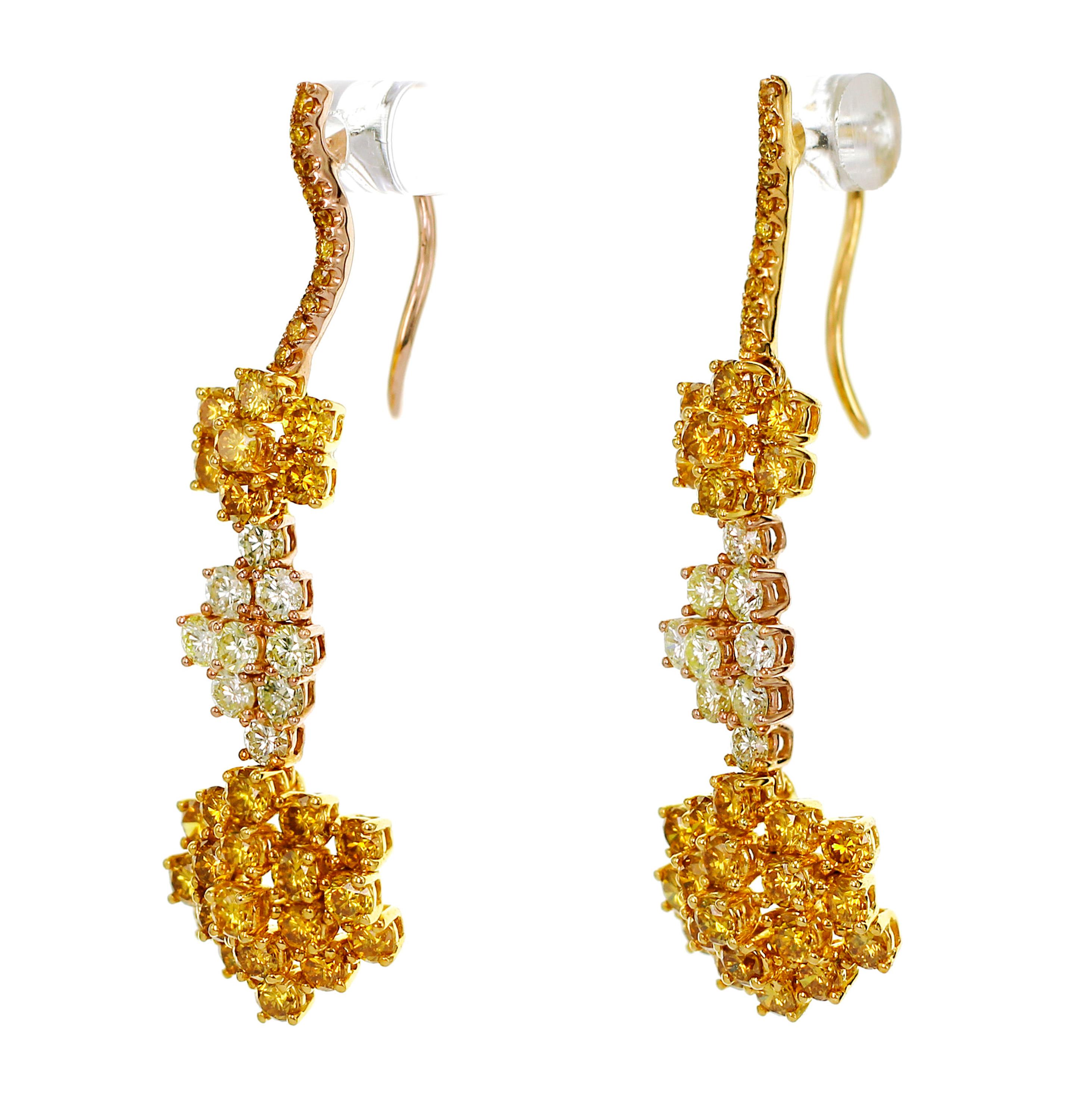 A mix of fancy vivid yellow diamond and fancy light lemon color diamonds are set together in this hand made earring.
The clarity of the diamonds are VS 2.
If needed , we can make a certificate in Japan Laboratory or in NGTC in Hong Kong. 
