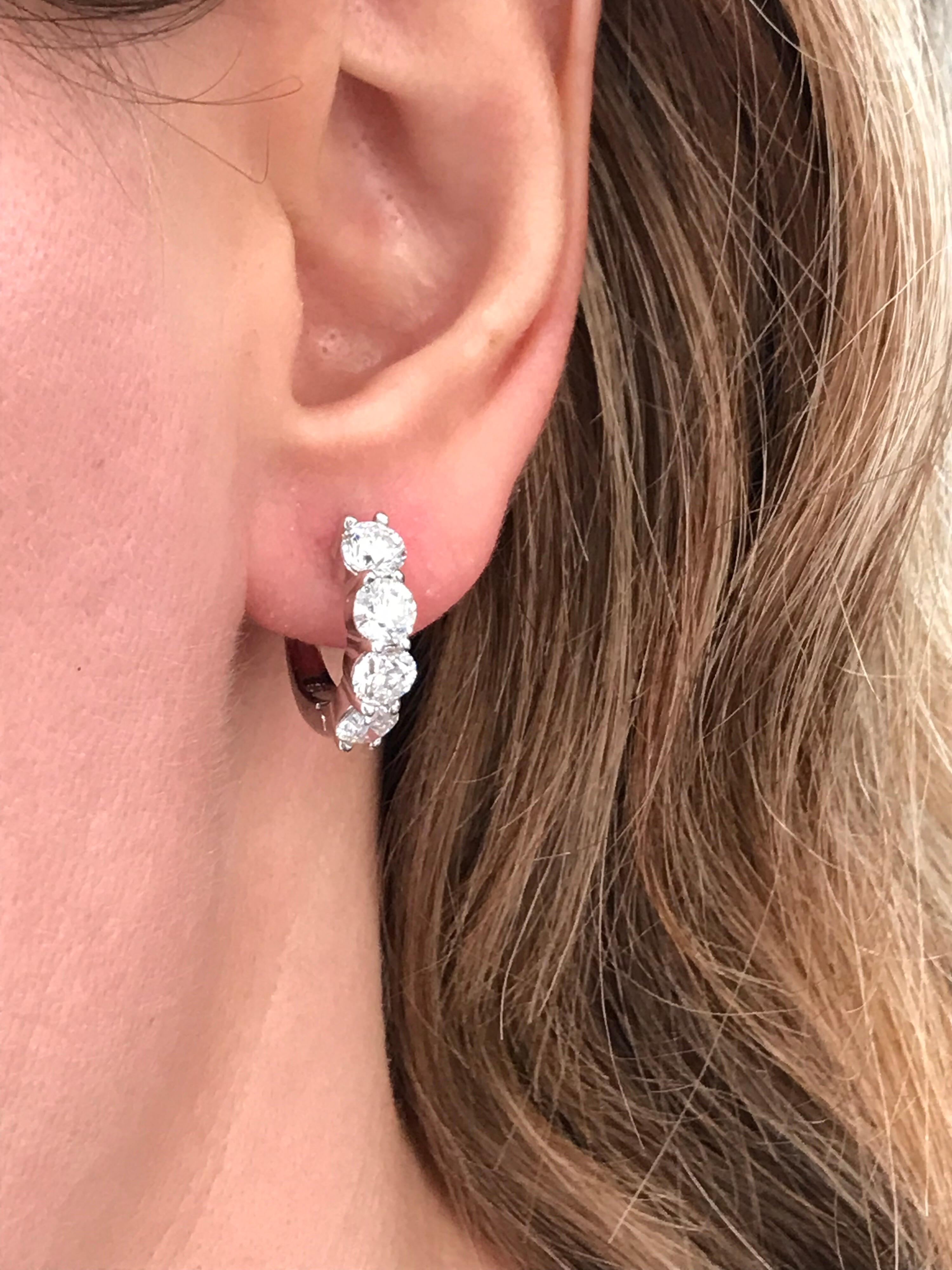 Each earring showcases four round brilliant diamonds set in a shared-prong hoop mounting made n 18 karat white gold. Diamonds weigh 3.84 carats total.

Style available in different price ranges. Prices are based on your selection of the 4C’s (Carat,