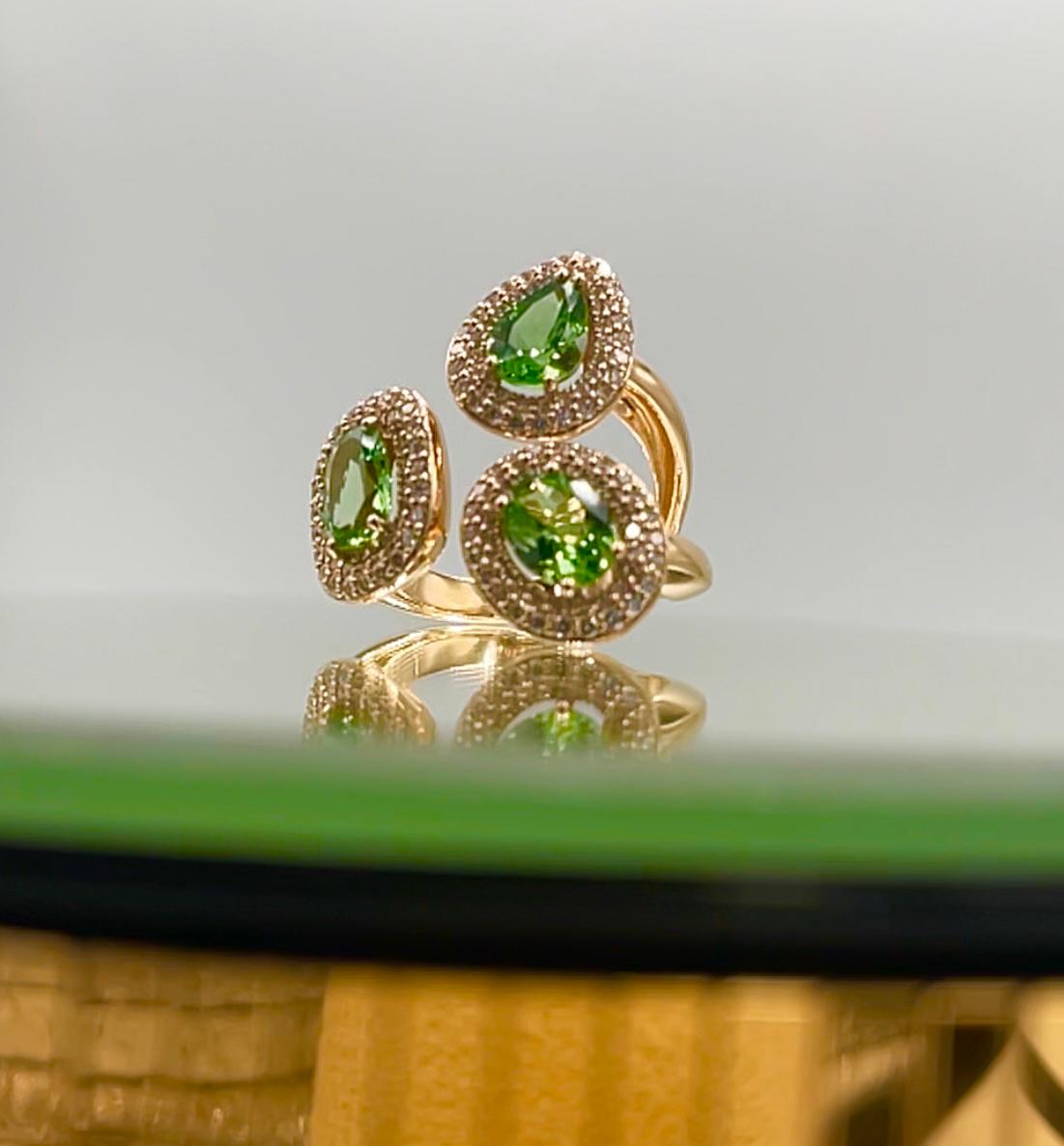 One of a kind three-stone “Didi” ring in 18 Karat rose gold 14,40g set with the finest diamonds in brilliant cut 1,03 Carat (VS/F quality) and 3 natural vivid tsavorites in double rose cut 3.84 Carat.

Because every tsavorite has his own irregular