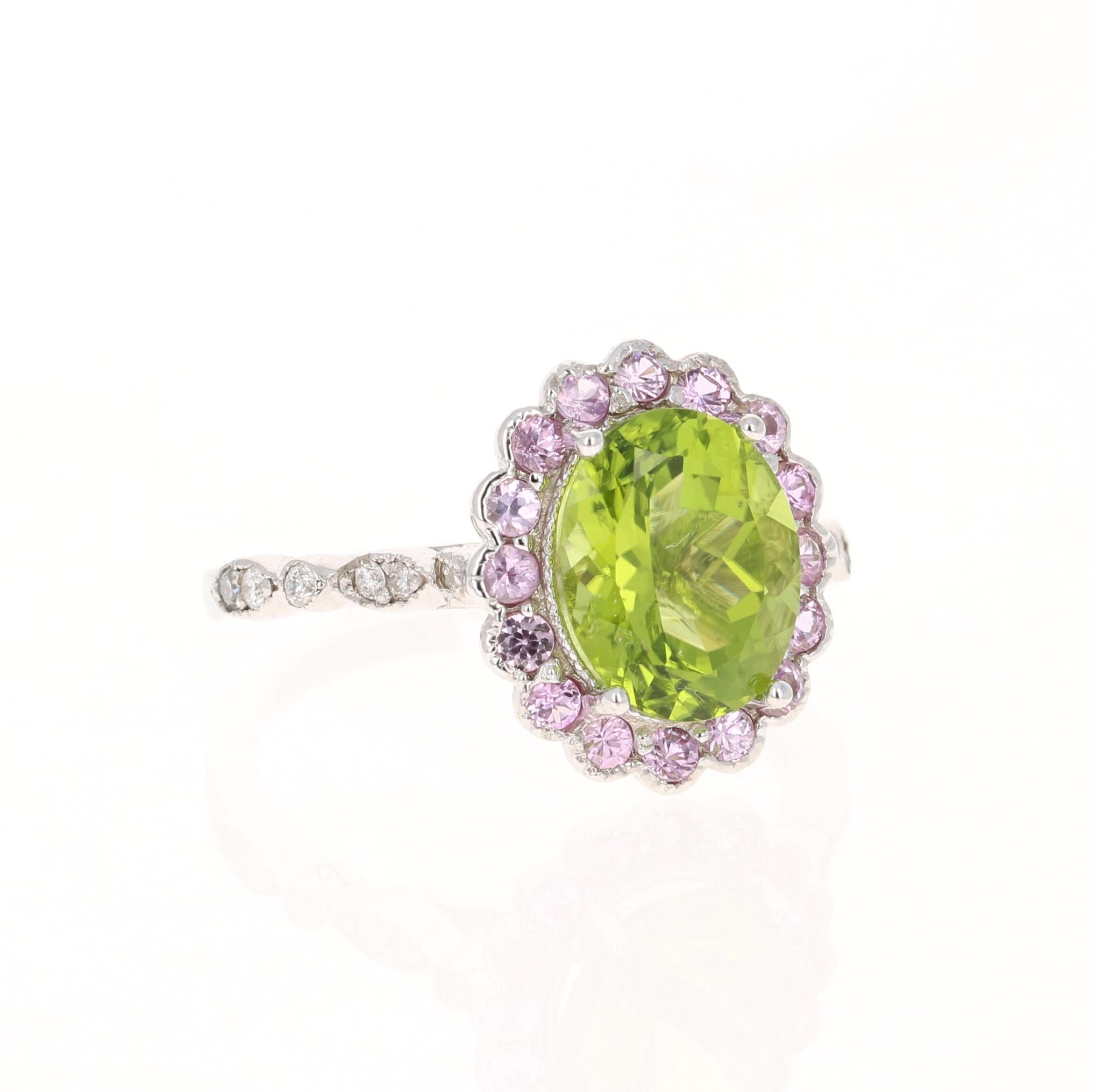 This ring has a 3.18 carat Oval Cut Peridot and 16 Pink Sapphires that weigh 0.53 Carats and 12 Round Cut Diamonds that weigh 0.13 carats (Clarity: VS, Color: H) The total carat weight of the ring is 3.84 Carats. The Peridot measures at 10 mm x 8