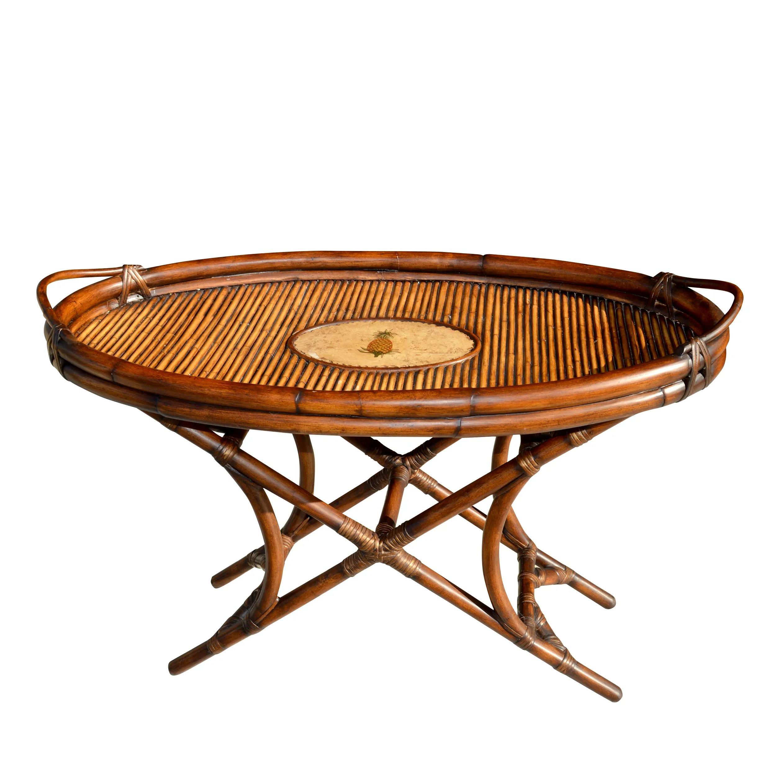 38.5? British Colonial style cane and bamboo tray table

Charming and perfect for serving cocktails or breakfast in bed, this vintage rattan butler tray features two cut-out handles for easy transport. The tray top is embellished with a pineapple.