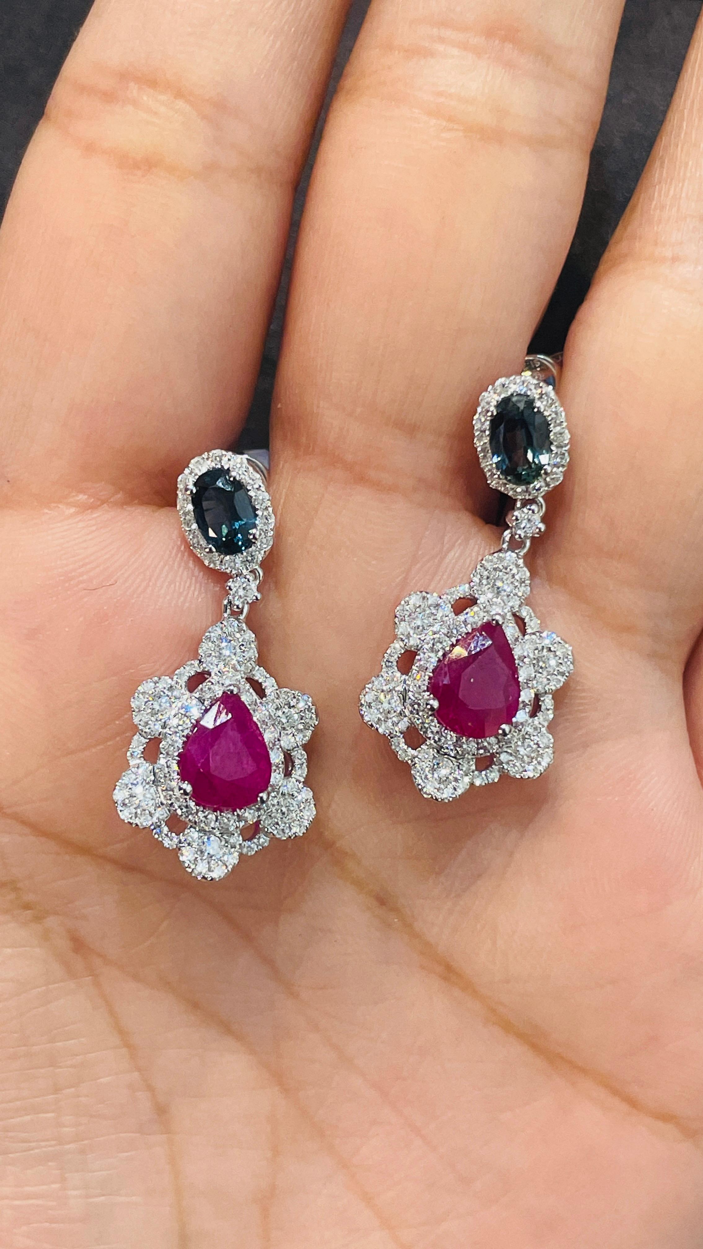 Ruby and Blue Sapphire Dangle earrings to make a statement with your look. These earrings create a sparkling, luxurious look featuring oval and pear cut gemstone.
If you love to gravitate towards unique styles, this piece of jewelry is perfect for