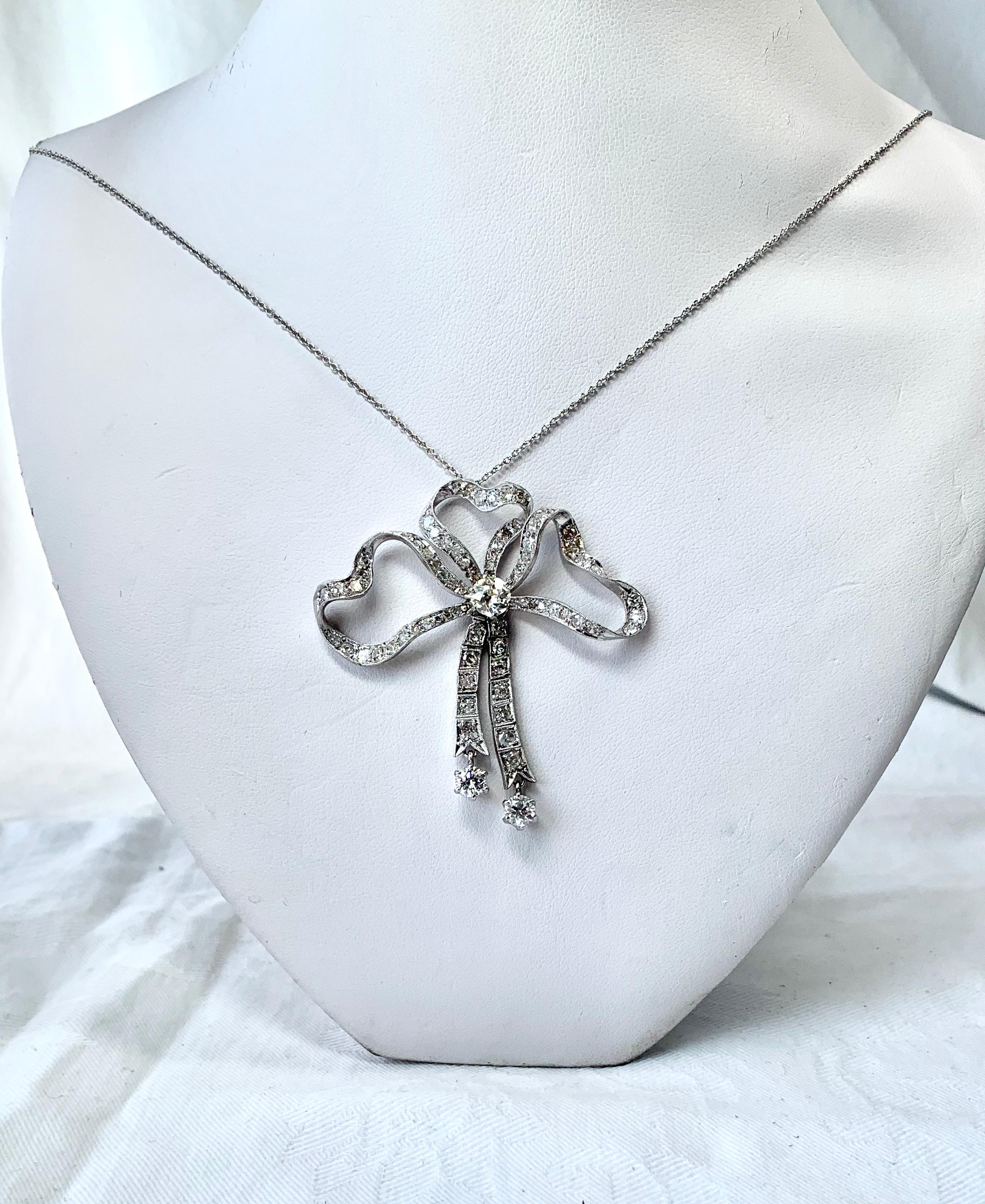 A stunning antique Victorian - Edwardian Platinum 3.85 Carat Diamond Pendant Necklace.  The gorgeous necklace is in a ribbon bow motif with articulated ribbons below.  The bow is set with 3.85 Carats of Diamonds in Platinum.  The central diamond is