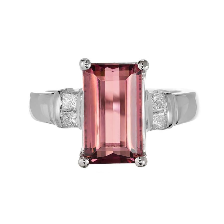 Discover the opulent elegance of our 3.85ct natural emerald cut pink Tourmaline and Diamond 14k white gold Cocktail ring, a masterpiece of luxury and sophistication. The center piece, a breathtaking pink tourmaline, that catches the light with an