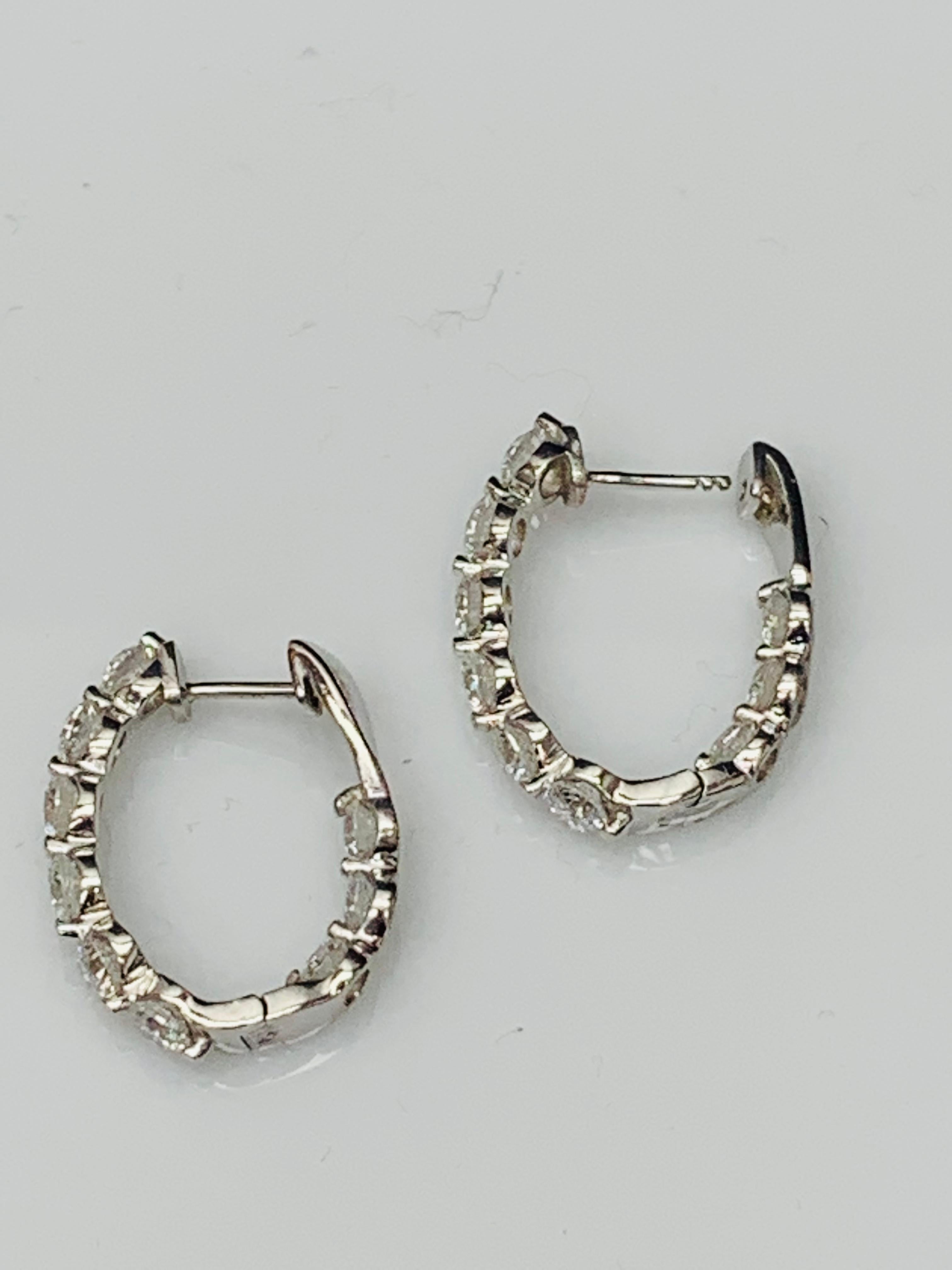A chic and fashionable pair of hoop earrings showcasing brilliant cut round diamonds, set in 14k white gold.  18 Round diamonds weigh 3.85 carats total. A beautiful piece of jewelry.


All diamonds are GH color SI1 Clarity.
Available in Yellow and