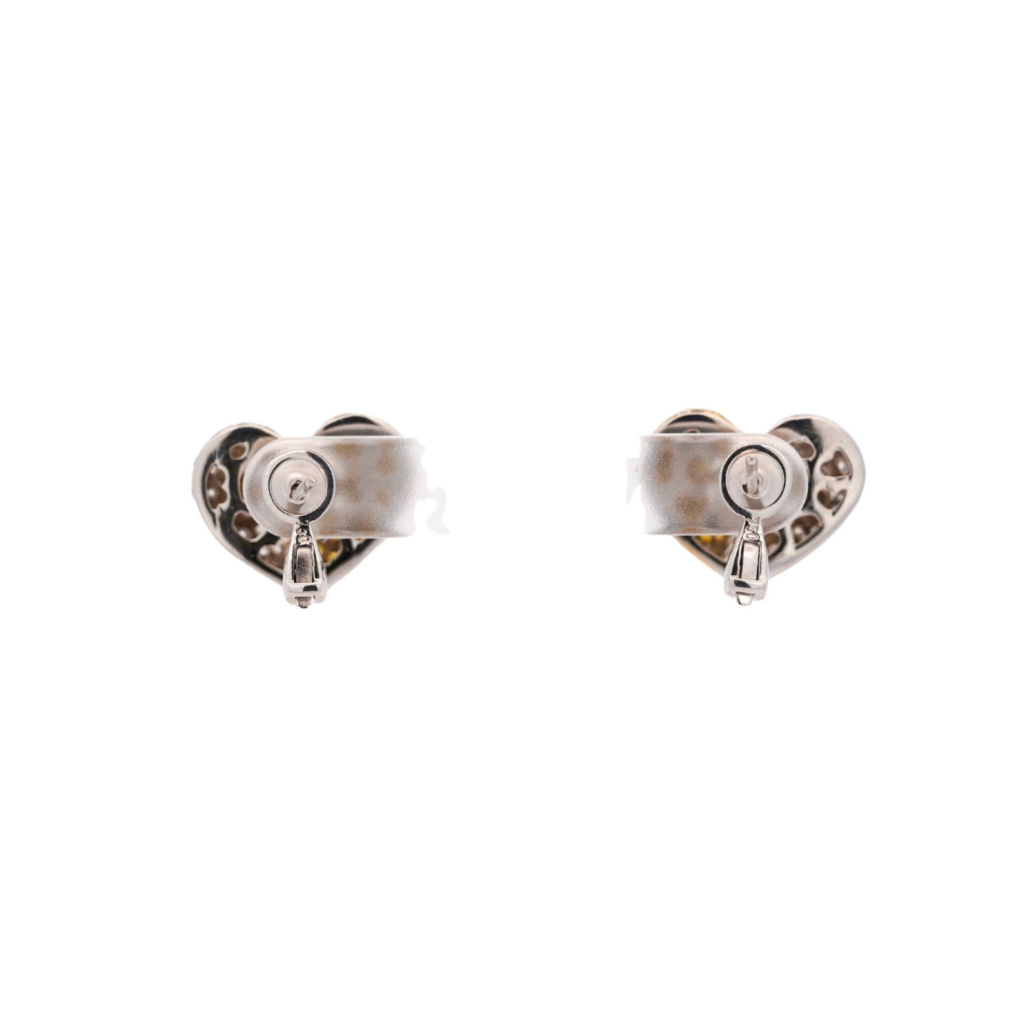 Natural 3.85 carat total weight diamond pave heart earrings in 18K white gold featuring yellow and white diamonds in split-heart design. Secure lever back closure with 18 x 14.7mm dimensions weighing 9.3 grams total.

Product Specifications:
Item