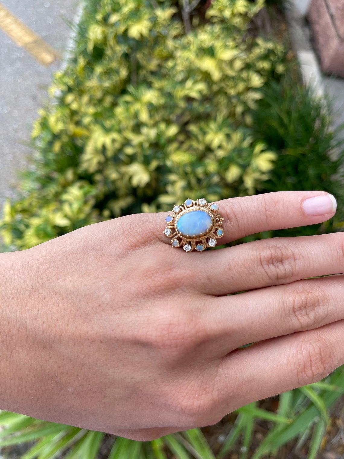 A magnificent, hand made vintage ring from the 1920's with extraordinary opals and diamonds. This grand piece is as impressive as it is beautiful. The focal point of the ring is a crystal opal displaying illuminating rays of fire and brilliance. The