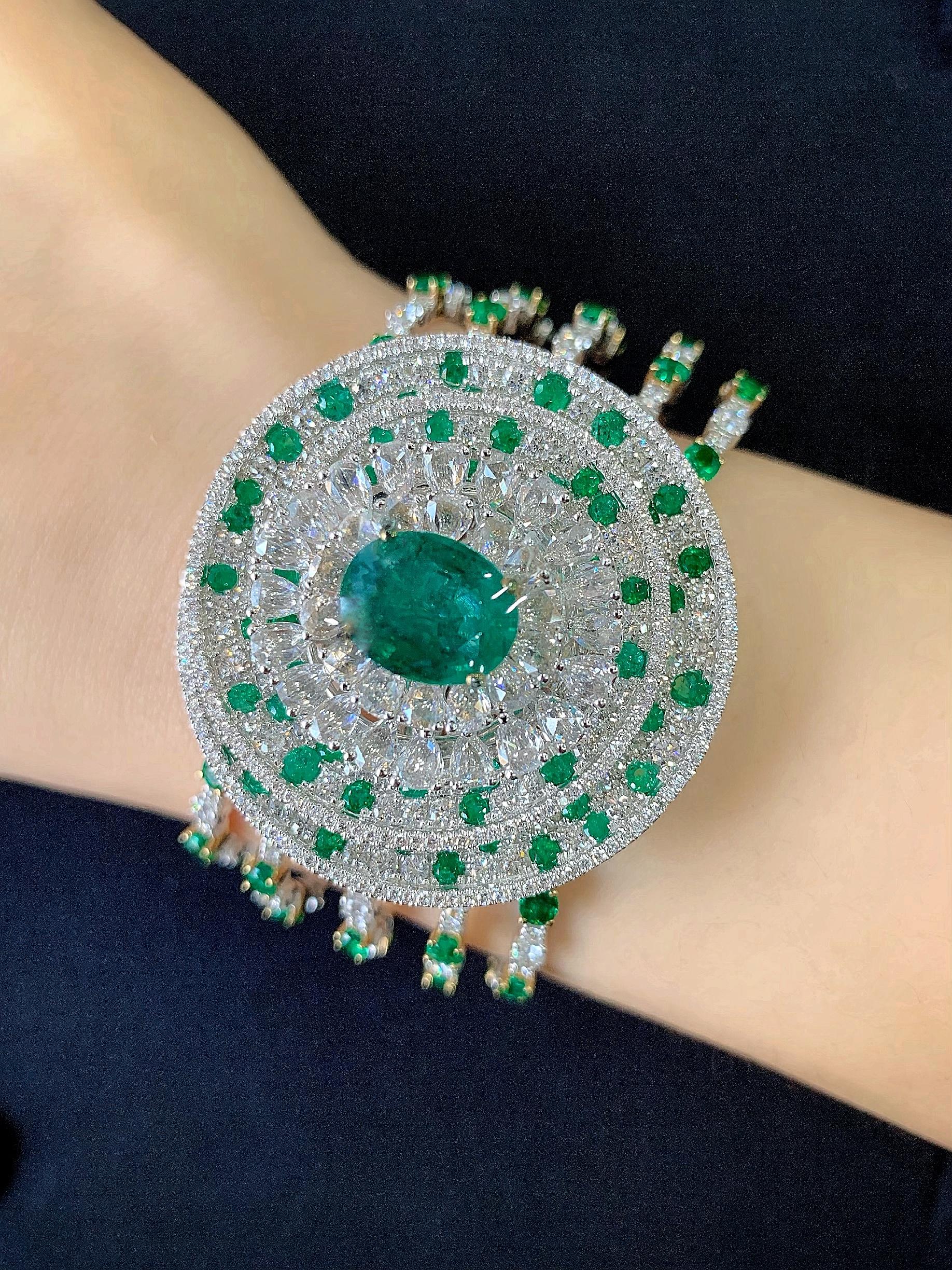 Every angle of Butani's cuff showcases the brand's attention to detail.  This stunning cuff bangle is handmade from 18 karat white and yellow gold and is centered with a striking 3.86 carat oval emerald illuminated by rose-cut and brilliant-cut