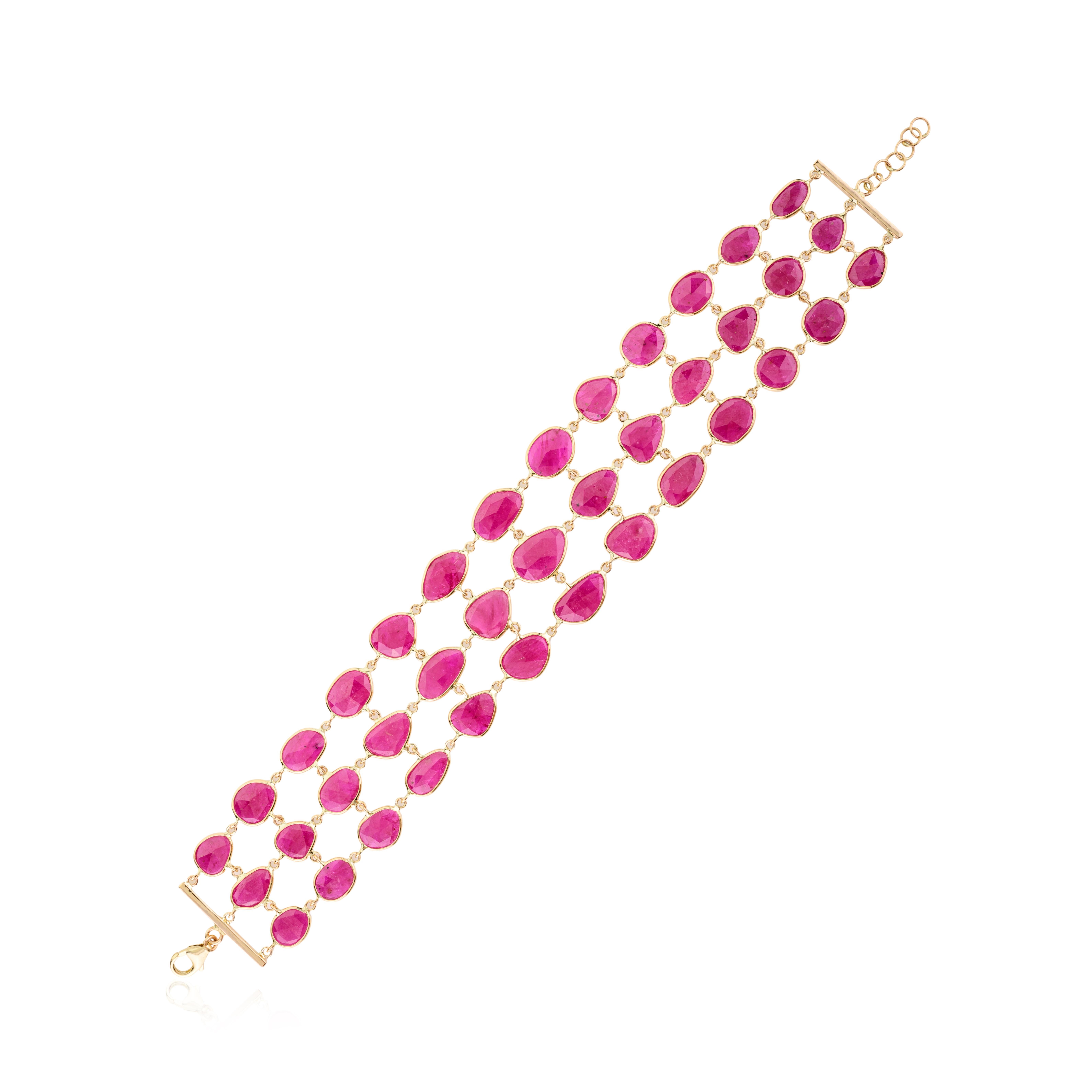 This 38.6 Carat Uneven Ruby Wide Bracelet for Women in 14K gold showcases endlessly sparkling natural ruby, weighing 38.6 carats. It measures 7 inches long in length. 
Ruby improves mental strength.
Designed with perfect uneven cut ruby in gold to