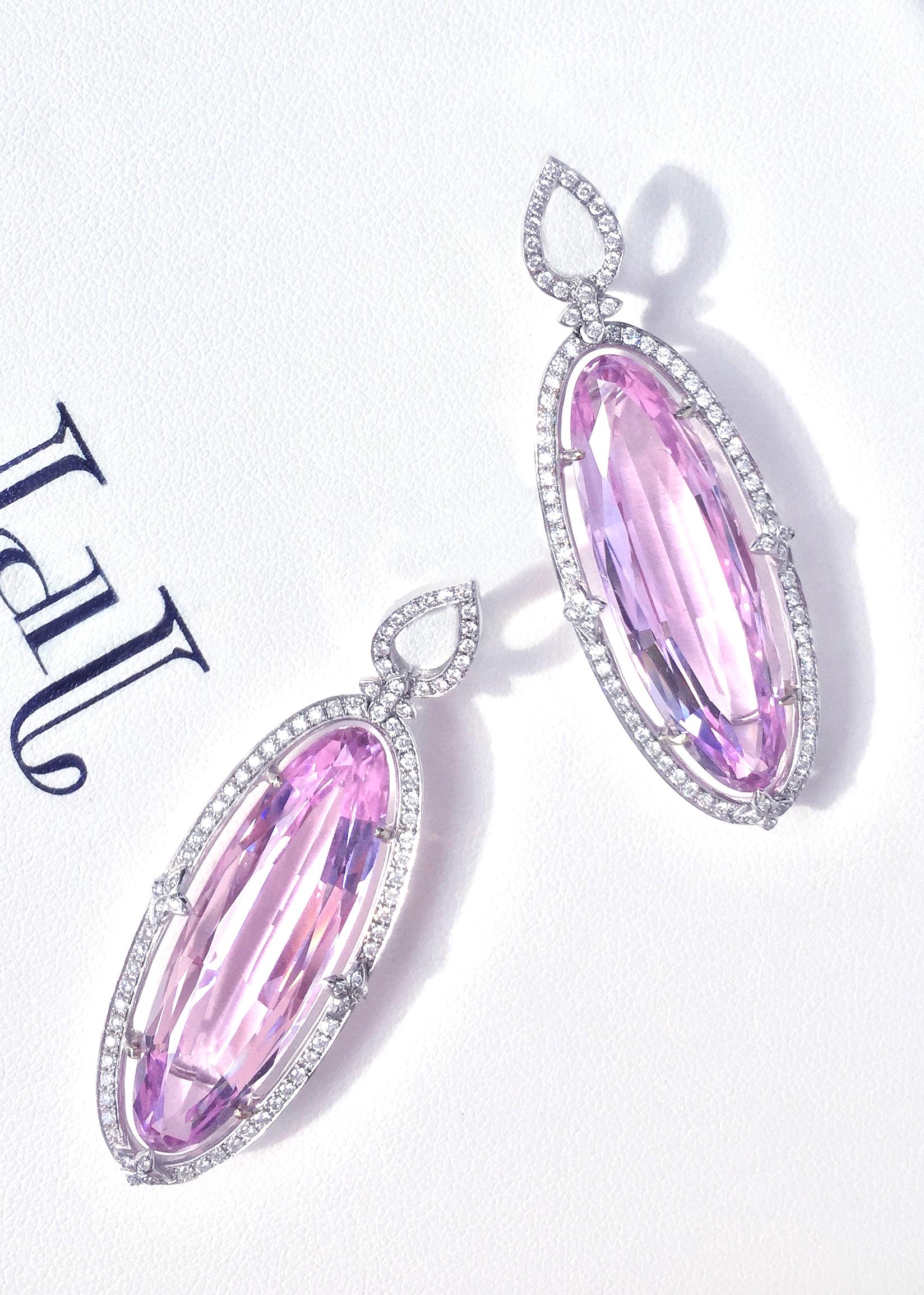 Oval shapped pink kunzites weighing 38.60ctw framed with brilliant cut diamonds and pear motif totalling 1.22ctw , VS/G+ set in 18k white gold with an omega style backing.