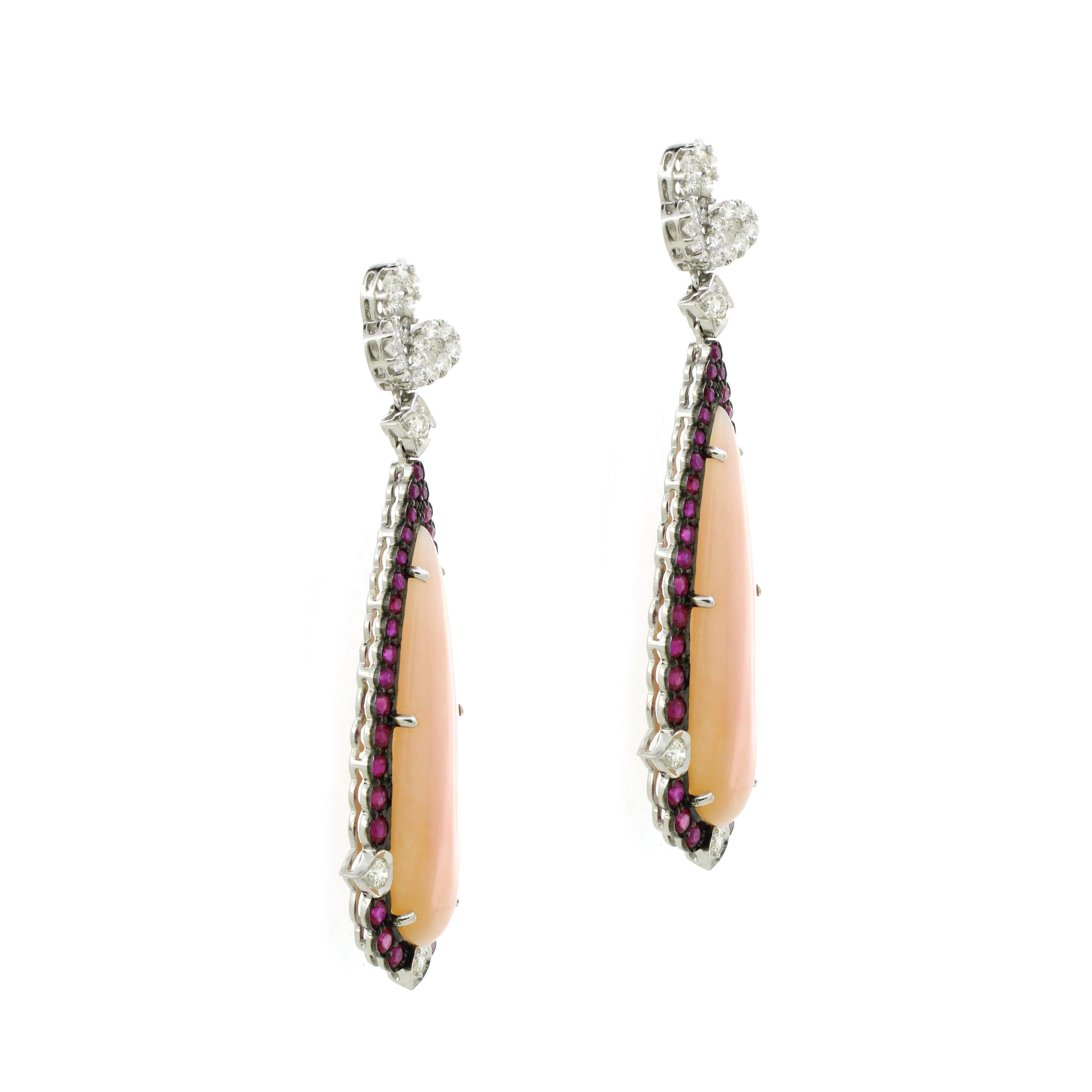 Introducing our exquisite Pink Opal Drop Earrings, a stunning blend of elegance and vibrant color. Each earring features a magnificent pink opal weighing 38.62 carats, exuding a soft, ethereal glow that captivates the eye. Surrounding these
