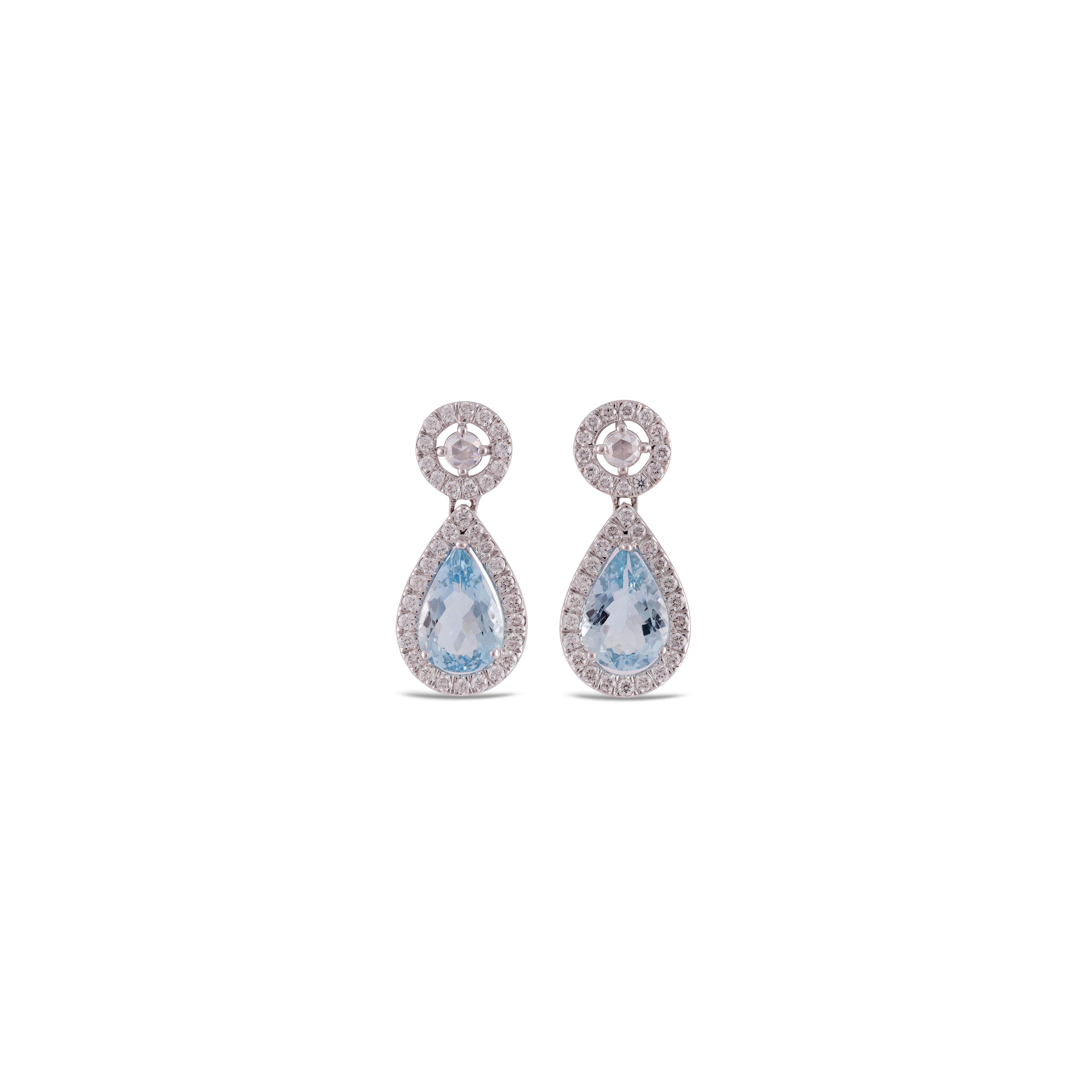 This is an elegant Aquamarine & diamond Earring studded in 18k gold with 2 piece of Pear 0r Drop Cut  shaped  Aquamarine weight 3.87 carat which is surrounded by 72 pieces of round shaped diamonds weight 1.53 carat, this entire ring studded in 18k